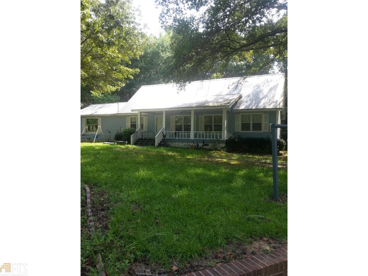 1.5 story home sitting on private 5.74 acres. Has a detached 15 x 18 shop with 110/220 power and plumbed for water. Has 2 metal out buildings and a old barn. Is in the South Paulding school district. Home is maintenance free vinyl siding. Has nice metal roof. Interior needs some updating. Hardwood floors under the carpet. Has large enclosed back porch. Home also has public water and a well.