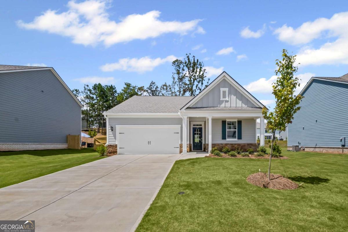 Welcomes you to 65 Grove Springs Court, a new construction single-family home in Parkside at Carter Grove community. This Cali, 4 bedroom and 2 bathroom ranch floor plan home, has a lot to offer your family in the 1,774 square feet. Your family can enjoy spending time outside in the large, flat backyard. A long foyer leading to the main living area and bedrooms welcomes you as you enter this home from the front porch. At the front of the home, 2 secondary bedrooms are split by the guest bathroom. Each bedroom boasts a walk-in closet, including the 3rd bedroom that is the perfect size for an office space or guest bedroom. The laundry room sits right outside of this room providing easy access for all to do laundry. Continuing deeper into the home, you walk into the open concept kitchen and living area. The chef in the family will enjoy all the kitchen has to offer including, stainless-steel appliances, granite countertops, white shaker cabinets, and a large walk-in pantry. An oversized island separates the kitchen from the dining area. Enjoy spending time with family and friends in the spacious living room or outside on the covered back patio. The primary suite is tucked away to the back of the house, off of the living room, providing privacy homeowners can use to relax and unwind. The primary suite comes with a considerable walk-in closet, dual vanity, and separate walk-in shower and soaking tub.