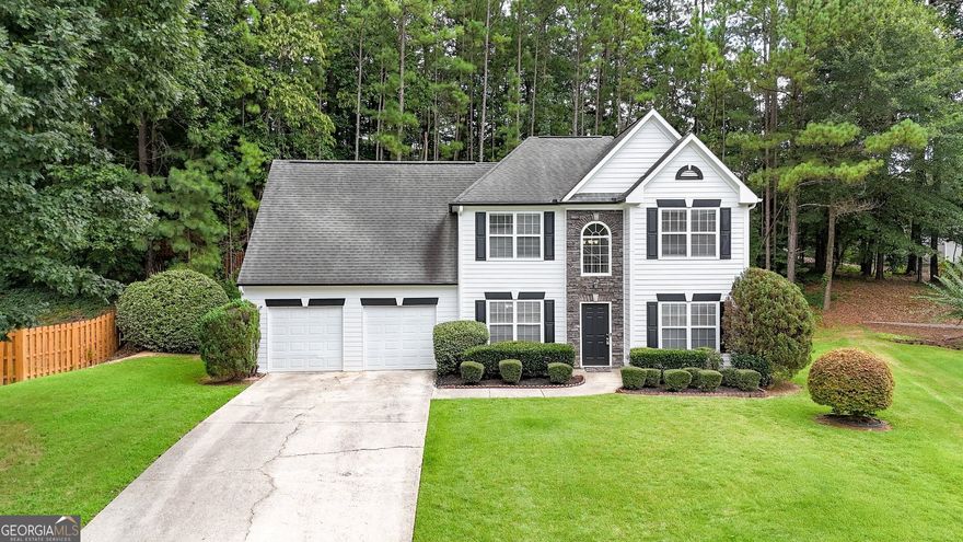 Beautiful Home in Milford Woods - Pool, Tennis, High-Speed Internet & Cul-de-Sac Living!  Welcome to this charming 3-bedroom, 2.5-bath home in the highly desirable Milford Woods community, where you'll enjoy high-speed internet, swimming pool access, tennis courts, and the tranquility of cul-de-sac living!  Step inside to a warm and inviting foyer, flanked by a formal dining room and a versatile den or home office-perfect for today's flexible lifestyle. At the heart of the home is the open-concept kitchen, complete with hard-surface countertops and a seamless flow into the impressive 2-story family room, filled with natural light and anchored by a cozy gas log fireplace-ideal for chilly evenings and comfortable gatherings.  Just off the kitchen, you'll find a convenient laundry room, keeping daily tasks simple and efficient. Upstairs, two spacious secondary bedrooms share a full bath, while the expansive primary suite offers a relaxing retreat with a sitting area, tray ceiling, walk-in closet, and a luxurious spa-like bath featuring a double vanity, soaking tub, and separate shower.  Recent updates include brand-new carpet on the stairs and second-floor bedrooms, plus new flooring throughout the main level, giving the home a fresh, modern feel. Outside, enjoy private backyard living with a patio perfect for grilling and entertaining. A spacious 2-car garage provides plenty of room for storage and convenience.  Unbeatable location: Just 20 minutes from Six Flags Over Georgia, 25 minutes from The Battery Atlanta and Cumberland Mall, and only moments away from Walmart, Kroger, restaurants, and a variety of shopping options-all while nestled in a peaceful, quiet neighborhood.  This move-in-ready home has it all-style, comfort, connectivity, location, and community amenities.  Schedule your private showing today-this one won't last!