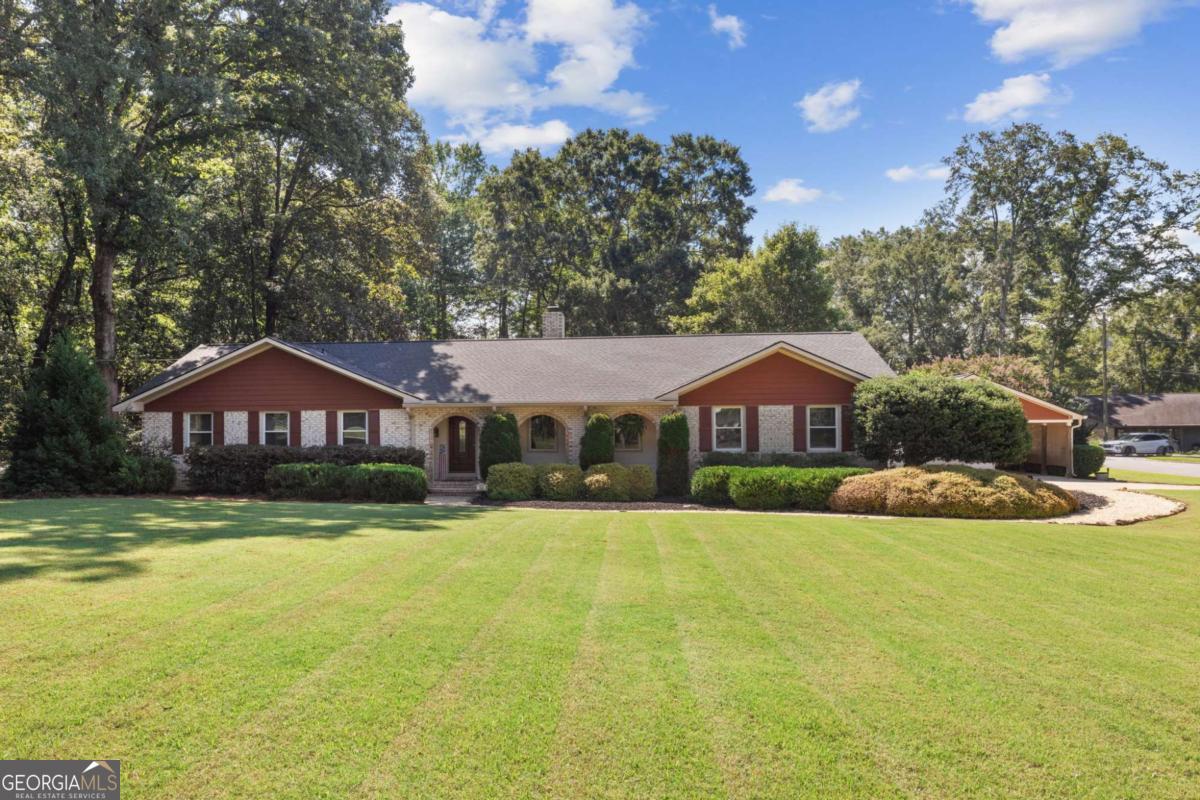 Welcome to this meticulously maintained 3-bedroom, 2.5-bath ranch home nestled on a picturesque 1-acre corner lot in a quiet cul-de-sac. Conveniently located near shopping, dining, and entertainment, this property offers both privacy and accessibility. Inside, you'll find a spacious layout featuring a cozy stone fireplace in the sunken den, a Jack-and-Jill bathroom, and a versatile fourth room that can serve as a bedroom, office, or flex space. The home has been thoughtfully updated with recently replaced double-pane windows, new appliances, modern lighting fixtures, and fresh interior paint, newer roof. The outdoor living space is just as inviting, with a large private deck, a relaxing hot tub, and plenty of room for entertaining family and friends. A detached garage and carport provide ample parking and storage, with potential to convert into a studio apartment if desired. Nature lovers will appreciate being only minutes away from the scenic walking / biking trail along McNutt Creek.