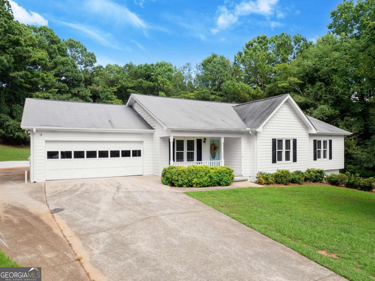 Immaculate, Move-In Ready Ranch with Full Basement in Gainesville! This charming and well-kept 4 BED / 3 BATH home offers tons of space, inside and out! You'll love the extra-large bedrooms, beautiful hardwood and tile floors, and the fully finished basement with a second living room, full bath, and bedroom-perfect for guests, teens, or in-laws. The basement also features a drive-around access and its own garage door. Step outside to a huge back deck, patios, and a large, grassed backyard that's both private and perfect for entertaining or relaxing. Located less than half a mile from Lake Lanier, you'll have easy access to the water with a public boat ramp just down the road at Mountain View Park. This one checks all the boxes-space, location, and condition. Don't miss it!