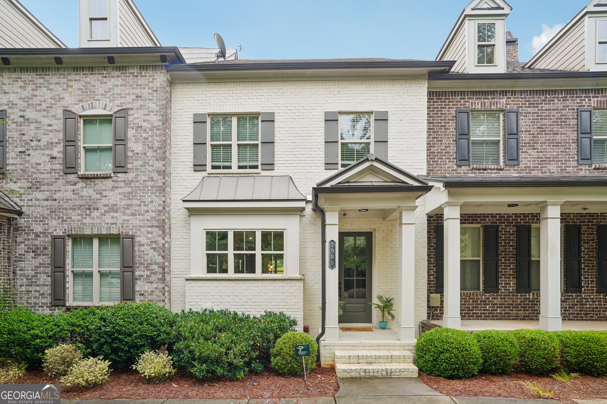 Luxury Townhouse in Encore Walk! Located in the heart of Alpharetta, this beautiful listing sits in an exclusive community of just 38 homes. Enjoy a bright and spacious floor plan with upgraded wood floors, custom built-ins, enhanced lighting, a custom kitchen featuring quartz countertops, a built-in island with ample storage, soft-close drawers and cabinets, and an expansive kitchen window boasting natural light and trees. The primary suite features a large walk-in shower and custom closet built-ins. The finished basement offers a versatile space for guests, work, or recreation. Perfectly positioned near Alpharetta staples - Big Creek Greenway, Ameris Bank Amphitheatre, Topgolf, and Avalon. This home delivers both style and convenience in a truly sought-after setting.