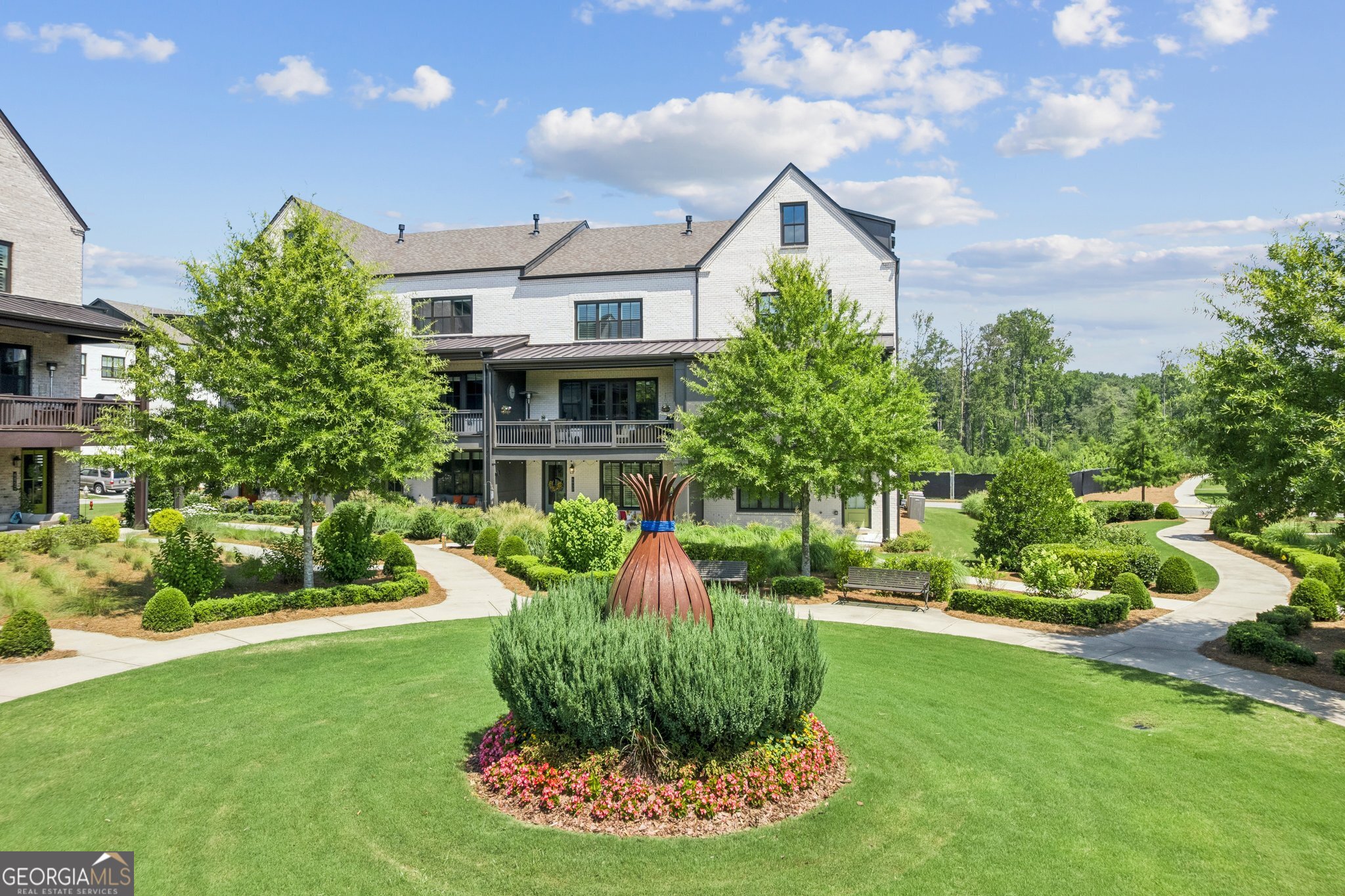 Experience Unmatched Views and Luxury Living in the Heart of Halcyon Experience the Halcyon lifestyle on one of the most coveted lots in the highly desirable Garden District of Halcyon in Alpharetta, GA. This exceptional home offers truly one of the BEST views overlooking beautifully landscaped green space with unobstructed views to Halcyon's vibrant shopping, dining, and entertainment district, the Big Creek Greenway, and beyond. And the sunsets? Absolutely spectacular! Unwind on your covered back porch or patio, where comfort meets calm. Surrounded by nature and subtle luxury, it's the perfect place to relax and enjoy the peaceful simplicity of home. This exceptional home showcases the sought-after Harleigh floor plan, the largest townhome model in the community offering a light-filled, open-concept layout with soaring 10' ceilings on main, plantation shutters, and a seamless blend of elegant design and everyday functionality across all three levels. Featuring four spacious bedrooms and 3.5 bathrooms, this elevator-ready home was built with premium upgrades and is perfectly positioned just steps from the heart of Halcyon. The expansive, welcoming front porch offers serene views of the lush greenspace, creating a perfect spot for outdoor relaxation and connection. Step into the inviting foyer, where you will find a versatile bedroom, home office, or flex space that is paired with a full tiled bath. Just beyond, the two-car garage offers sleek epoxy floors and a convenient side entry door for added functionality. The main level highlights a light-filled, open-concept design centered around a gourmet chef's kitchen, complete with premium stainless-steel appliances, an expansive island with bar seating, and a generously proportioned dining area, an ideal setting for elegant entertaining. The adjoining family room, anchored by a charming gas fireplace, seamlessly extends to a spacious covered deck through classic French doors, offering an inviting space to host guests or unwind amidst stunning panoramic views. A remote-controlled shade enhances both comfort and convenience. Upstairs, the primary suite offers a relaxing retreat with a tray ceiling, spa-like bath with dual vanities, and a frameless tiled shower. Two additional secondary bedrooms share a well-appointed full bath, and a hallway laundry area completes the upper floor. Community amenities include a pool, clubhouse, large courtyard, expansive green spaces, and direct access to the Big Creek Greenway. Zoned for top-rated Forsyth County schools with easy access to GA-400 and surrounded by exciting new developments-including the proposed and highly anticipated "The Gathering", this area is quickly becoming one of the most sought-after destinations north of Atlanta. Don't miss this rare opportunity to live in luxury, surrounded by nature and just steps from the best of Halcyon. Schedule your private tour and see why this home offers more than just a place to live, it's where everyday living feels extraordinary.
