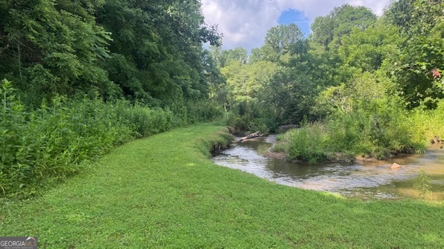 Beautiful creek front lot with mountain views. Perfect opportunity for a retreat in the mountain with 170' of creek frontage. Plenty of room to fish, swim or just relax.