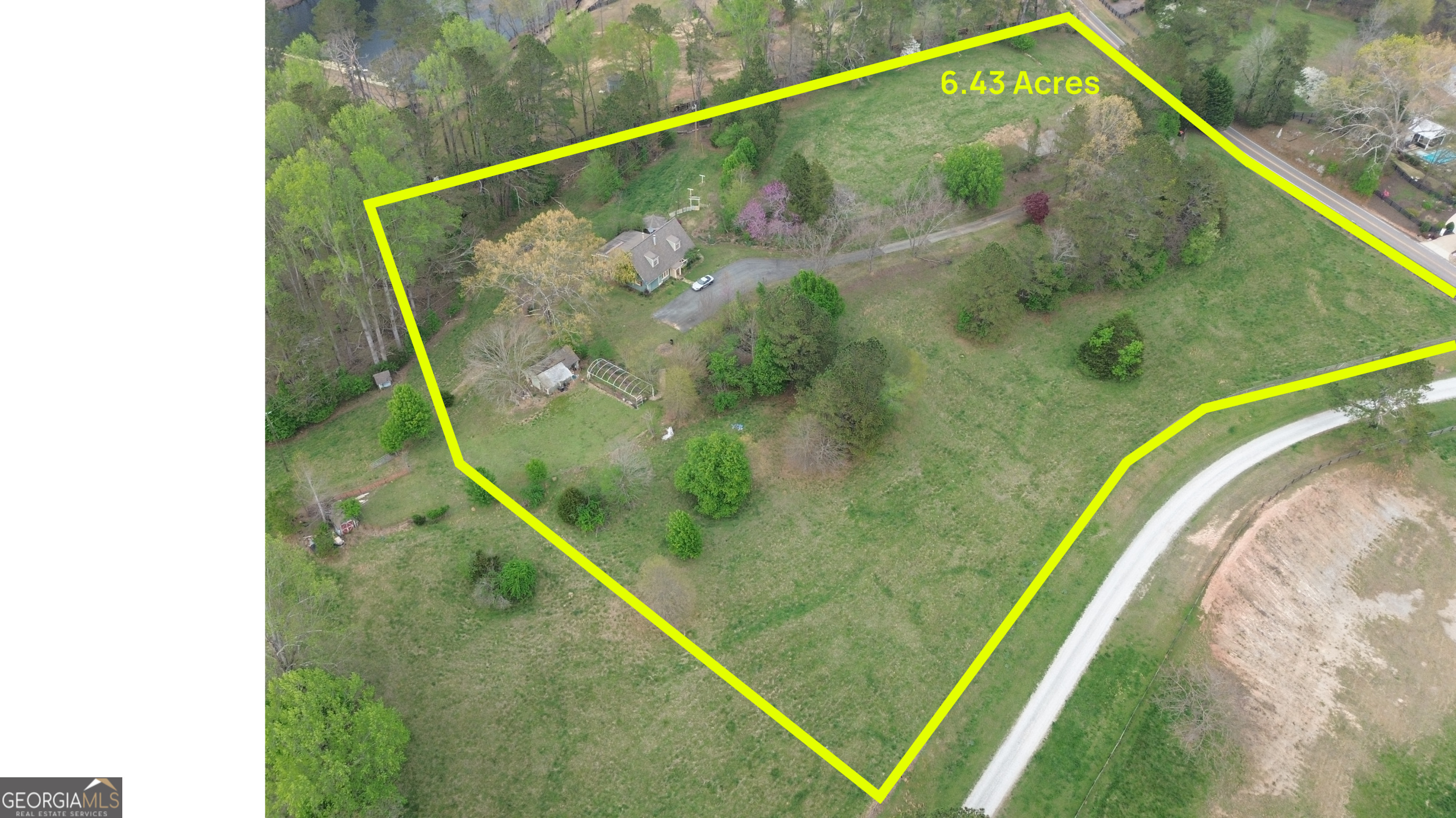 Discover an incredible opportunity to own 6.43 acres of prime land in the highly sought-after city of Alpharetta, right off Liberty Grove Road-all with the added benefit of lower Cherokee County taxes. Situated in the heart of Alpharetta's horse country, this expansive property offers endless possibilities for custom home builders or buyers looking to create their dream estate in a serene, private setting. This property boasts dual road frontage on Liberty Grove Road and Rivendell Lane, providing the potential for multiple access points and enhanced flexibility for development. The elevated hilltop setting offers stunning views, making it an ideal backdrop for a luxury home. An existing home sits on the property, but the true value lies in the land-offering a blank canvas for a custom estate or future development. The property includes a small cemetery (0.16 acres), with easement rights retained by the previous owners for future access and maintenance. Enjoy the perfect blend of privacy and convenience, with easy access to top-rated schools, shopping, dining, and major highways. Whether you're envisioning a private estate, family compound, or signature build, this property offers the space and potential to bring your vision to life.
