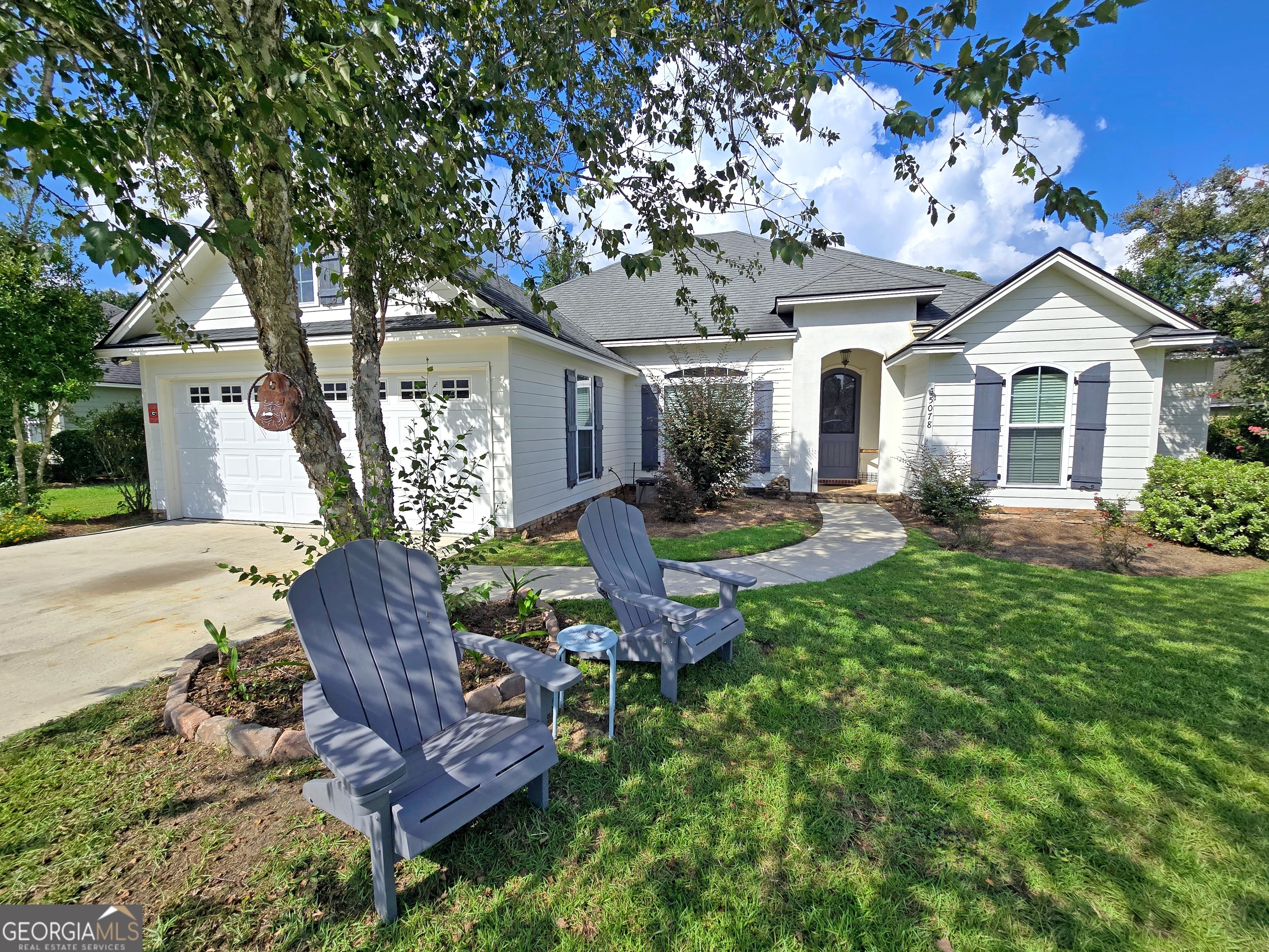 This 4BR/2BA home in the desirable Grove Point Community offers style, comfort, and convenience with access to a neighborhood pool and park. Inside, the open split floor plan features a formal dining room, a living room with a coffered ceiling, and a kitchen with custom cabinetry, granite countertops, and stainless steel appliances. The spacious master suite includes French doors to the screened back porch, a large walk-in closet, and an en suite with his-and-hers sinks, a soaker tub, and a tile shower. Enjoy no rear neighbors, a large fenced backyard, and a screened porch complete with a cozy fireplace-perfect for relaxing or entertaining. This home blends modern finishes with a warm, welcoming design in a sought-after community.