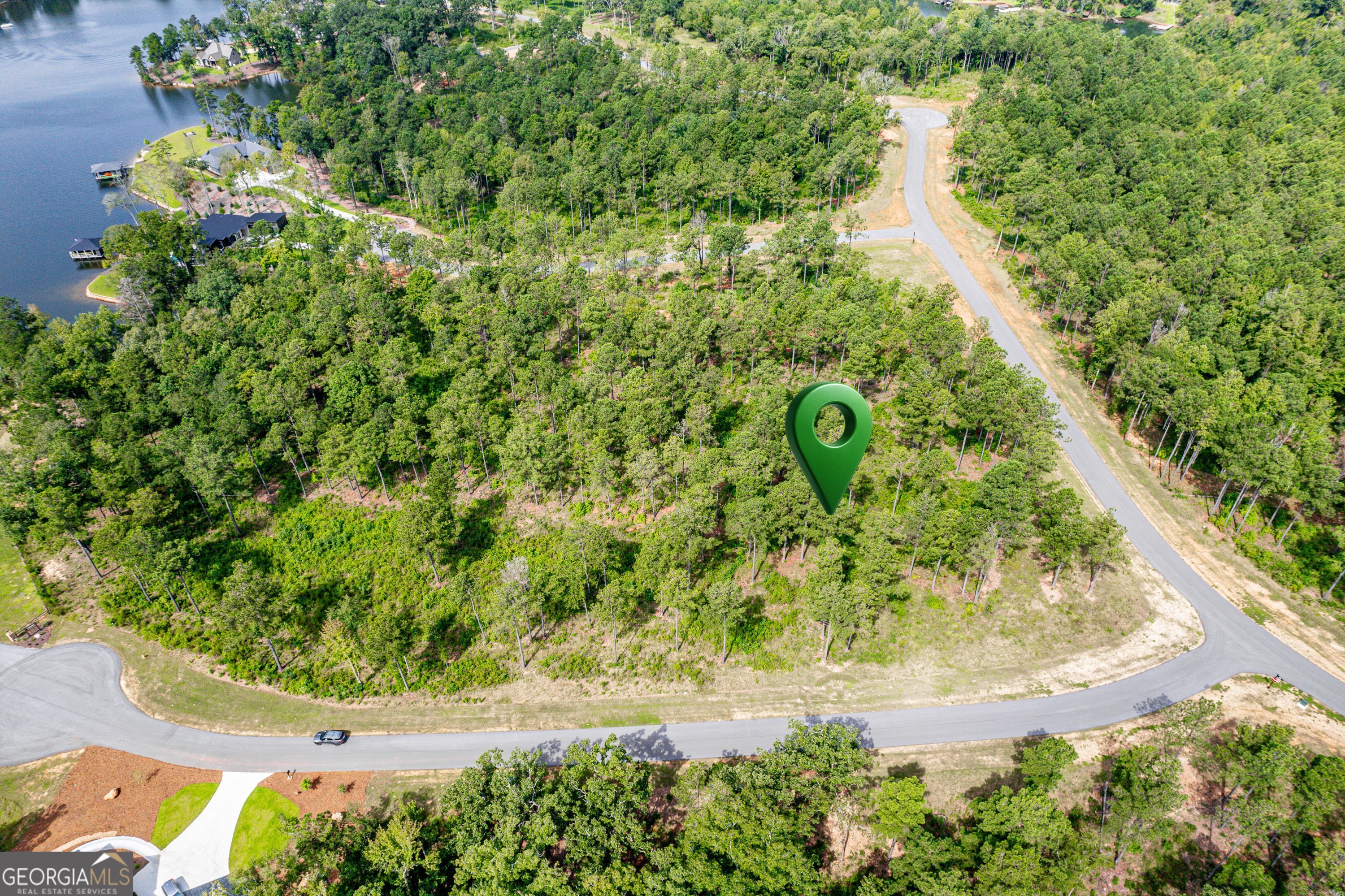 Lot 63 The Falls at Lake Sinclair Discover the perfect setting for your dream home in The Falls, a premier gated community just 15 minutes from downtown Milledgeville. This gently sloped lot offers stunning year-round lake views, making it an ideal spot to design a home that blends comfort with natural beauty. Residents of The Falls enjoy access to top-notch community amenities, including a sparkling pool, private boat ramp, and even a fun putt-putt course. This lot is within walking distance to the fabulous amenities. Whether you're seeking a full-time residence or a weekend retreat, this lot provides the perfect balance of convenience, recreation, and relaxation.