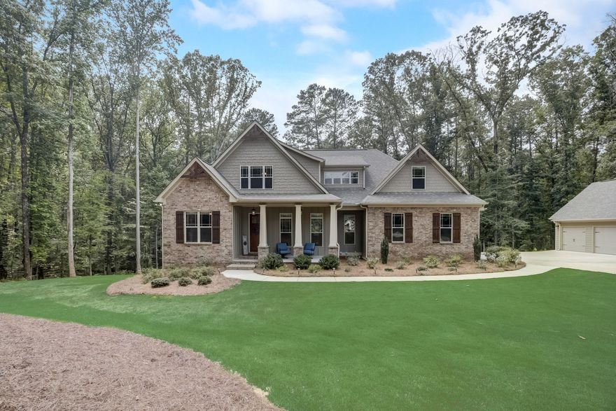 If you are looking for privacy, you will adore this custom craftsman home nestled in the woods on a quiet cul-de-sac street in sought after Brooks! This pristine 7BR/4BA custom home sits on 5 private acres with a full finished basement and upgrades galore!  Enter the foyer and notice beautiful red oak hardwoods throughout the main level. The eat in chefs kitchen is an entertainers dream with Jenn-Air stainless steel appliances, a large island and custom cabinetry. The family room features custom built-in cabinets and a stunning hardwood planked vaulted ceiling you will be sure to admire. You are sure to enjoy the serenity of just sitting on the lovely covered back porch on cool summer evenings! The spacious primary bedroom also features beautiful vaulted ceiling, plenty of closet space, an oversized on-suite bathroom with a large tile shower and separate soaking tub. The main level has a separate dining room and one secondary bedroom which could also be used as an office! This home does not lack any storage! Upstairs you will find 2 additional bedrooms with a shared jack and jill bathroom. There is a loft space which could be a great little sitting area or homework area for the kids! Do not miss the large bonus room which makes bedroom number 5! The recently finished terrace level has beautiful hardwood looking tile and top of the line plush carpet. The finished terrace level could be used as in-law suite with 2 additional generously sized bedrooms, a stunning full tile bathroom, a large living room and kitchenette area! There is also 2 storage rooms! The double doors lead you outside to the terrace level back porch with brand new under decking! You can enjoy the privacy and take in the fresh air! The upgraded septic system should not interfere with a future pool if you decide to create your own backyard oasis! Never worry about the power going out with the GENERAC HOME GENERATOR that was recently installed! Do not forget about the 640sqft DETACHED 3 CAR GARAGE! There is plenty of space for extra vehicles or fun toys! AWARD WINNING SCHOOLS! You are located just minutes to Peachtree City with easy access to many dining and shopping options!