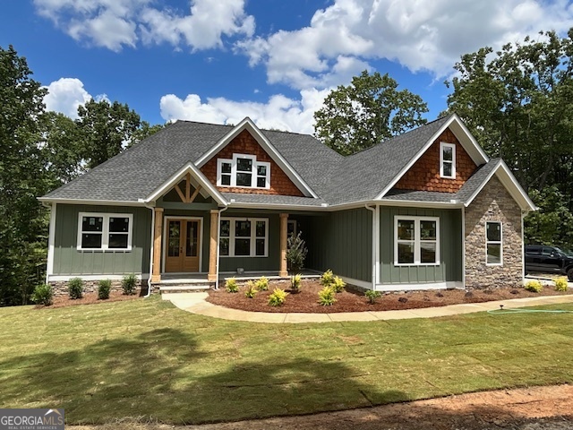 Discover your dream home with this stunning Craftsman-style residence, custom-built to blend timeless charm with modern luxury - NEW CONSTRUCTION, with an late August completion date. Nestled on a private, wooded lot, this meticulously designed home defines quality with carefully-selected materials, finishes and colors. The main level boasts an open-concept design, seamlessly connecting the living areas with high-end finishes and designer selections throughout. Step inside to find a spacious and inviting layout featuring a Family Room, with cathedral ceiling and stone fireplace, perfect for entertaining or everyday life. Double doors lead to the spacious covered deck with a wide, gorgeous view of the wooded yard. This plan offers a versatile Dining/flex room that can serve as an Office or Playroom. The home's luxurious features include a chef inspired kitchen with top-of-the-line appliances, exquisite cabinetry, huge island, walk-in pantry and beautiful countertops, along with stylish bathrooms, detailed woodwork and many upgrades. This split bedroom home features the Primary Suite and two secondary Bedrooms on the main level. The Primary Bedroom offers a peaceful view of the wooded backyard, tray ceiling, ceiling fan and recessed lighting. The luxurious Bathroom features a separate freestanding tub and seamless shower along with beautiful vanity cabinetry and large walk-in closet. Upstairs, in addition to a 4th Bedroom and full bathroom, you'll find a generous Bonus Room, providing added flexibility to suit your lifestyle. Upgrades in this home are plenty, and include engineered hardwoods (no carpet), spray foam insulation, tankless water heater and tiled showers in every bathroom. On the covered back porch and covered patio, enjoy the serene beauty of your 3+ acre, private, peaceful, wooded lot, offering a private, peaceful retreat in a quiet neighborhood. There's plenty of room to grow with a full, unfinished, walkout basement that opens to a covered patio. Ductwork installation allows for future 9 ft ceilings, and this basement is stubbed for a bathroom and bar/kitchen. Bonus 3rd garage door in this basement level. Oversized, 2-car garage at kitchen level offers storage space and walk-through door. Experience the best of both worlds - modern upgrades and a charming, craftsman aesthetic in this exceptional home, built by Builder Solutions LLC. Don't miss out on the opportunity to make it yours! NOTE: Representative photos - Not of actual home. These Photos are of a similar floor plan previously built by the same builder. Features and finishes will be of similar quality, but will differ in the actual home