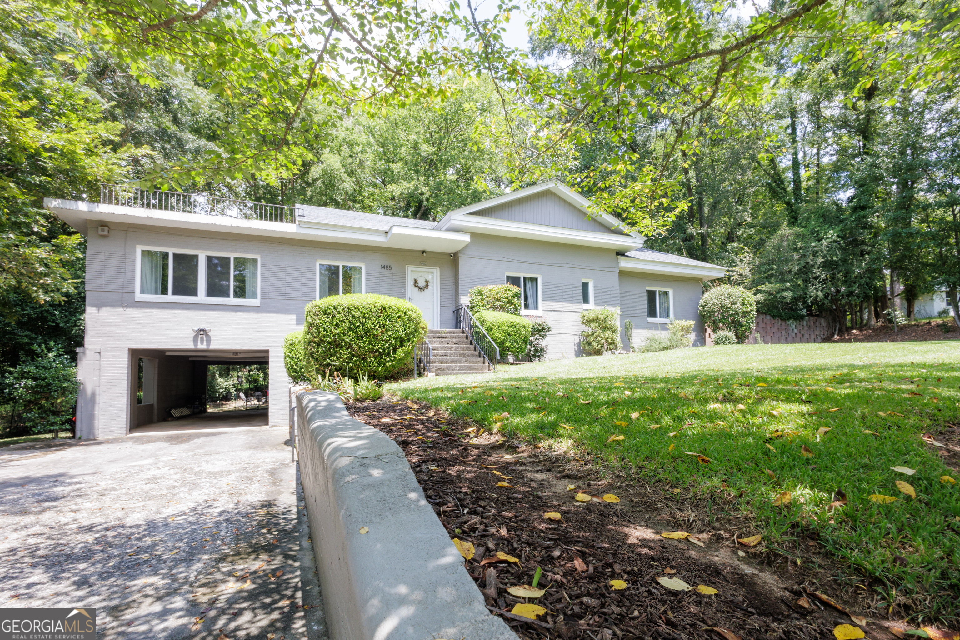 Tucked beneath towering hardwoods on 1.5 private acres, this mid-century split-level ranch blends classic 1950s charm with generous modern space. A freshly painted exterior, low-pitched roof and broad picture windows create crisp curb appeal, welcoming you into light-filled living. Inside, an airy main level flows from a sun-splashed living room to an open dining area-perfect for gatherings. Three well-sized bedrooms and two full baths offer comfortable retreats, while the partial upper level gives you flexible bonus space for a home office, playroom or studio. Step outside to an expansive, park-like backyard where there's room for gardens, pets, a fire-pit or even future additions. With no HOA and ample frontage, the possibilities are wide-open-add a workshop, pool, or keep it simply as your own wooded oasis. Located minutes from downtown Macon shopping, dining and I-75/I-16 access, yet feeling worlds away from the bustle, 1485 Lone Oak Dr delivers the rare combination of acreage, mid-century character and in-town convenience. Bring your vision and make this classic Georgia home your own!