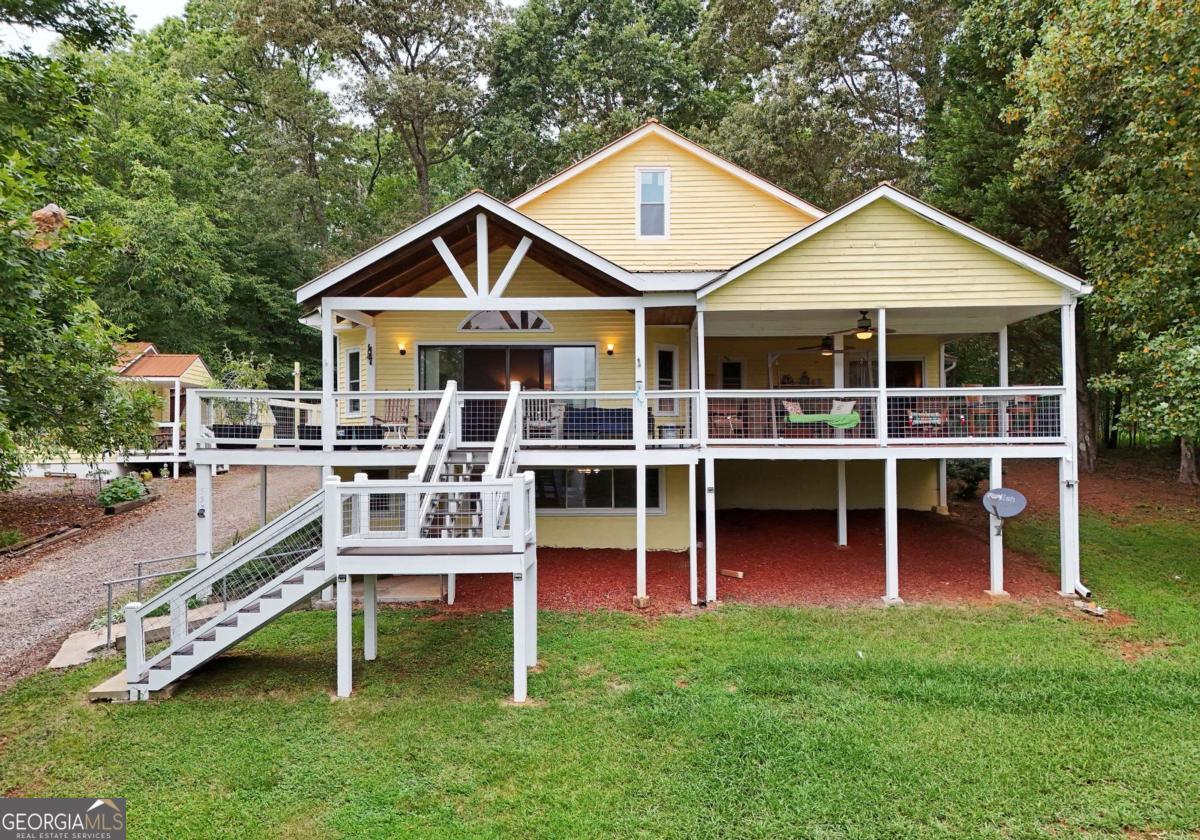 Stunning Mountain views, walking path to the lake and 2 homes. The estate consists of a total of 6 free-standing buildings. The 2/2.5 main house, the 2/1 guest house, a 12 x 14 hobby hut, lined with floor-to-ceiling shelving, a utility shed, a two-car garage and gazebo. Situated at the end of the road on 2 lots, very private property offers year-round, clear views of Bell Mountain from the decks of both homes. TVA-owned land borders the property on two sides, enhancing both privacy and tranquility. The main house features a 1st floor master bedroom and bath, complete with a separate sitting area, creating a spacious, comfortable retreat. The kitchen is big enough to accommodate multiple cooks, offering a generous wood-shelf pantry, an eat-in dining area, and a half bath. Every aspect of the home is "family-sized," giving ample space for gatherings and daily living. A large, naturally bright living room with wood flooring and a built-in entertainment center with fireplace forms the heart of the home. A 4 panel slider with decorative transom lead out to the wrap around deck with of low-maintenance TREX flooring. Leaving more time for you to enjoy that breathtaking panoramic mountain view. The same no-maintenance decking is found on all decks and stairs, plus all 6 buildings have approximately 5-6 years new copper metal roofs. The finished lower level has 2 rooms large enough to create a "mother-in-law" suite. The 2nd bedroom boasts a private entrance to the covered porch, a gas fireplace, built-in wood cabinetry with drawers and full bath. The space also includes a versatile bonus, family, or game room, perfect for relaxation, entertainment or 2nd kitchen and living area. That's just the main house! The 2/1 guest house has a stunning view, wrap around screened and open balcony, full kitchen, open to living area and stacked W/D. Buy it for you and your family. Rent the cabin to reduce the mortgage payment. So much to say, so little space. Come see it for yourself!