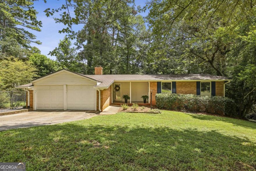 Welcome HOME to the most charming home in Brookhaven's coveted Sexton Woods! So much NEW - FRESH interior paint, BRAND NEW LVP throughout, NEWLY painted kitchen and bathroom cabinets with NEW, on-trend hardware, NEW STAINLESS STEEL appliances, NEW light fixtures, NEWLY stained deck, painted shutters, NEWER HVAC, NEWER ROOF, and so much more... move right in and enjoy!!!! Three spacious bedrooms and two full baths on main make this the perfect first home, rental/investment property and so much more... the opportunities are endless with the space, not to mention daylight unfinished BASEMENT with interior and exterior access... just waiting to be finished!!! Plus, spacious TWO-CAR GARAGE! Beautiful, newly-refinished deck off kitchen walks right out to fully-fenced, flat, usable, private WALK-OUT BACKYARD!!! So many opportunities... eat-in kitchen features large island and ample cabinet, counter and storage space, cozy living room boasts gorgeous fireplace... natural light abounds through the three bedrooms... primary suite offers spacious walk-in closet.. so much to love!!!! From the moment you step onto the rocking-chair, picturesque front porch, you'll feel right at home. LOCATION cannot be beat... nestled in dreamy Sexton Woods, minutes from all that Brookhaven, Chamblee and more have to offer... walking distance to local favorite shops, businesses, restaurants like Pure and Henri's, Publix and more... a short walk to Keswick Park which offers dog park, playground, soccer fields, tennis/pickleball courts, you name it... minutes from Murphey Candler Park, Downtown Chamblee, Brookhaven Village, GA-400/285, and so much more. Don't miss your chance to call this MOVE-IN READY house HOME!