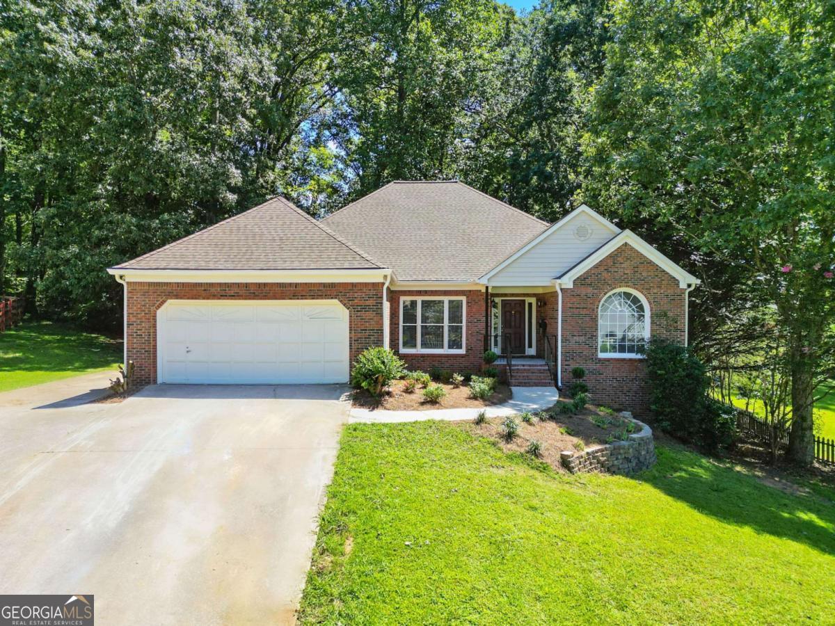 You'll love this beautiful brick-front, updated ranch in a well-established swim community. As soon as you enter, the soaring two-story foyer bathed in natural light, designer paint and gorgeous refinished hardwood floors will catch your eye. Every detail of the home was thoughtfully renovated with a designer's eye. The spaces all flow perfectly into each other making a modern open living space. That space is flanked by a study/office and a formal dining room. The kitchen is a showstopper with new cabinets, granite, custom backsplash and stainless-steel appliances. It opens to the living room with a beautiful gas starter fireplace. The breakfast area leads out to a large covered porch and a deck perfect for grilling. The wooded yard offers lots of privacy space to play. The blend of indoor and outdoor spaces is ideal for hosting large gatherings with family and friends. The vaulted ceilings throughout give it a wonderful bright open feel. The master bedroom with trey ceiling has a private bath with a brand-new double bowl vanity, large soaking tub and a separate shower. The two secondary bedrooms are nice sized and share a full bath with tub shower combo. Head downstairs to the finished basement with brand new mini-splits and you'll quickly realize this home has so much more space than you expected. The massive family room has plenty of room for watching movies, playing ping pong and anything else you can imagine. The oversized bedroom has a full bath, walk-in closet and a kitchenette. Numerous other finished and unfinished areas give you endless options. This home is Move-in ready with fresh paint, new bathroom vanities, new plumbing and electrical fixtures, newer roof and HVAC system and so much more. You'll be proud to call it home! This home has easy access to Dallas Hwy and Barrett Parkway. It's close to shopping, dining, top rated schools and minutes to Avenues at West Cobb, Kennesaw Mountain and Marietta Square. Owner has not lived in the property so limited disclosures. As a nice bonus it has the benefit of low Cobb County taxes!