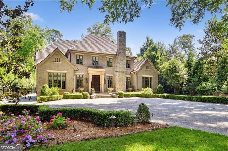 One of Historic Brookhaven's finest with a grand and gracious entry. This incredible custom home on a 3/4 acre level lot features a main level Master with a soaring ceiling and two spacious walk-in closets plus a beautiful marble bath. Spectacular warm rich walnut flooring is throughout the main and upper levels and unique and beautiful ceilings are in each room. Every custom feature imaginable is included in this home with arches throughout, a curving limestone stairway, a covered porch with a fireplace that opens to the expansive back yard with a large heated saltwater pool, and a spectacular attached guest apartment complete with a kitchen and sitting area. The main kitchen has an island topped with a unique Canadian limestone that looks like woodgrain, double dishwashers, a coffee bar, and copper faucets at the double sinks. An expansive private office on the main level fits well with today's lifestyles. The upper level of the home has 3 king-sized bedrooms, each with an ensuite bath and walk-in closet. There is also a second laundry room and a beautiful upstairs entertainment room or second office. The lower level has a media room, a full bath, a workout area, and limitless storage. This home has been beautifully designed by renowned Atlanta architect, Linda McArthur and was built by Ladisic Fine Homes.