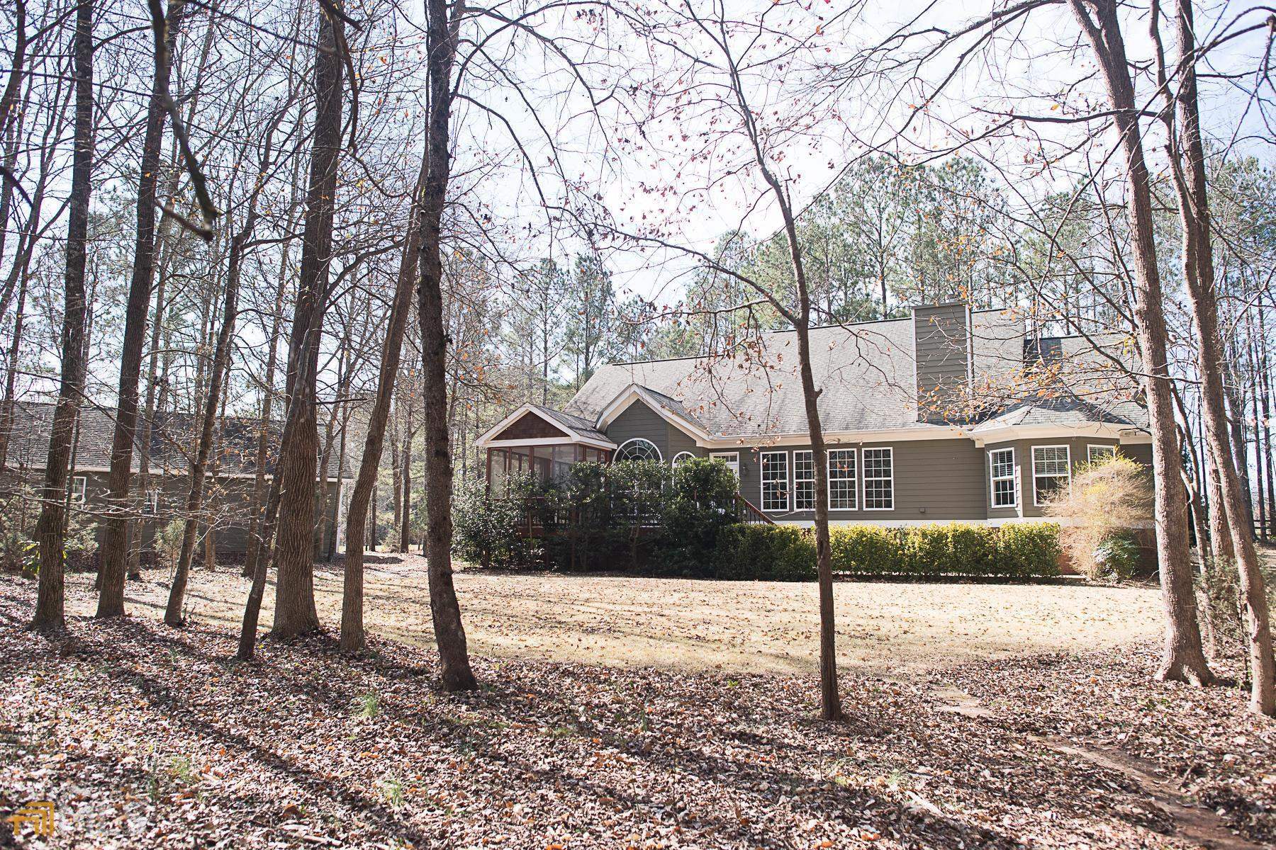 When you need space but location and convenience is a must, this is the perfect house for you to call home. Newer HVAC's, tankless water heaters in both houses and separate septic tanks and just the start. Elegant gated entrance to this 2acre, 5BR/3Bath (in the main house) with Master on main level & separate sitting area with updated en-suite included custom tile shower and double vanity. There is a separate office or could be 5th BR up front with a full guest bath with another custom tiled shower near by. Nice size DR and your LR with Trey ceilings and FP will accommodate all your guest and family but if you need more room, move out to your screened porch or large deck with pavers. If that's not enough, your kitchen is well equipped and even comes with a wine cooler ready to be stocked. Separate butlers pantry is perfect for overflow entertaining or extra space when needed. 2 car attached garage & 3 more BR's upstairs with full bath including tiled shower just top off the main house but we are not done yet. You have your own guesthouse/in-law suite/ or whatever you want to call it with a covered area for parking and could be another single car garage or party room. This space has its own private screened porch that will be your favorite spot to escape from all the chaos making this one definitely PickiVicki Approved! Private fenced lot with another outbuilding and lean-to that is perfect for parking your extra toys. No HOA and easy access to I-20. OWNER OCCUPIED WITH PETS AND ALARM so please do not approach house without an appt as Seller works from home. .