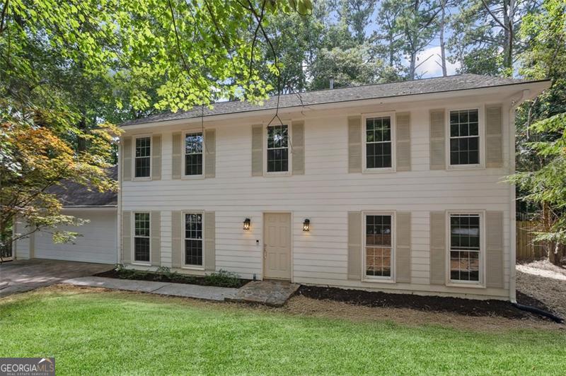 Step inside and feel the calm of 985 Lake Haven Ct. This home welcomes you with warmth and balance, where thoughtful design (including newer appliances, new HVAC, new flooring and fresh paint) and inviting spaces make daily life flow with ease. At the heart is a striking stone fireplace-It's the kind of feature that draws people together, whether for quiet evenings or moments of celebration. The kitchen, expansive, open and updated, is designed to support life as it happens. Morning light filters across the counters, casual meals stretch into conversation, and gatherings unfold naturally around the table. The level, shaded lot offers room to play, garden, or unwind, while the cul-de-sac setting creates a rare combination of privacy and community. There's space here for a firepit, a swing, or simply the quiet enjoyment of a cool summer afternoon or a Fall evening watching College Football. Tucked in a desirable, quiet neighborhood, yet close to everything, this home provides both retreat and convenience. Restaurants, shops, schools (highy rated) and everyday essentials are nearby, while GA400 makes commuting effortless. The details of this home work together to make it special, creating a lifestyle that feels intentional, timeless, and livable. This isn't just a house. It's a place where routines feel easier, spaces feel warmer, and life feels more your own. Welcome Home!