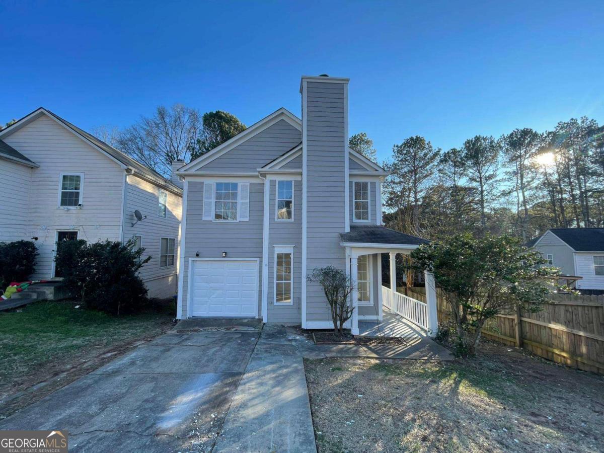 This charming home boasts hardwood floors throughout and an open main level filled with natural light. Relax by the fireplace in the spacious family room or entertain in the elegant dining room with crown molding and French doors leading to the backyard. The white kitchen features stainless steel appliances and overlooks a huge back deck, perfect for gatherings. Enjoy the privacy of a fenced backyard and upstairs, you'll find three bedrooms and two full bathrooms, including an oversized master suite with soaring ceilings and a large closet. With no HOA restrictions, this home offers both comfort and freedom. Plus, it's ideally located near restaurants, shops, supermarkets, and just 2 miles from I-85 for easy commuting.