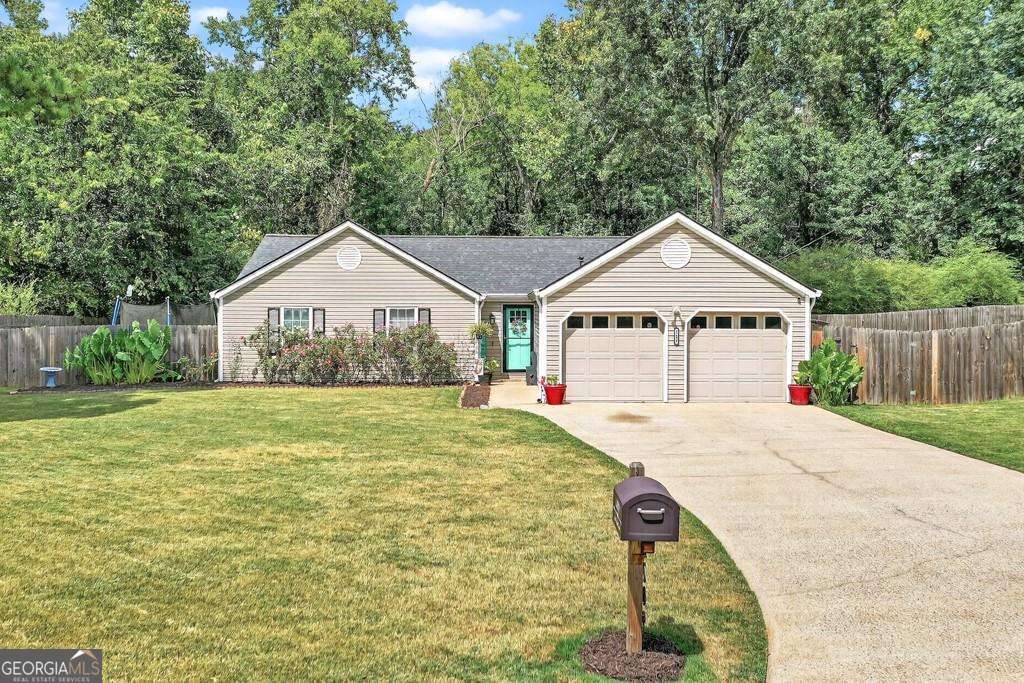 Welcome to this Charming 3-bedroom, 2-bath ranch offering an Open, Inviting floor plan! The Vaulted ceilings in the spacious Family room with a Cozy Fireplace flow seamlessly into the Kitchen and Dining areas. The Oversized Owner's suite boasts vaulted ceilings and a soaking tub with separate shower! Situated on an Amazing Private fenced lot at the back of a quiet neighborhood, one of the standout features is the expansive back patio overlooking the serene backyard-ideal for relaxing evenings or weekend entertaining. There is plenty of space both indoors and out, including extra room for parking your RV or boat. If all of that isn't enough, the Roof and HVAC are also recently replaced, along with many other Updates through out! This community is conveniently located to Interstates, Shopping, Grocery Stores, Schools, Trails, Parks and Entertainment. Don't miss the opportunity to make this Woodstock gem your own!