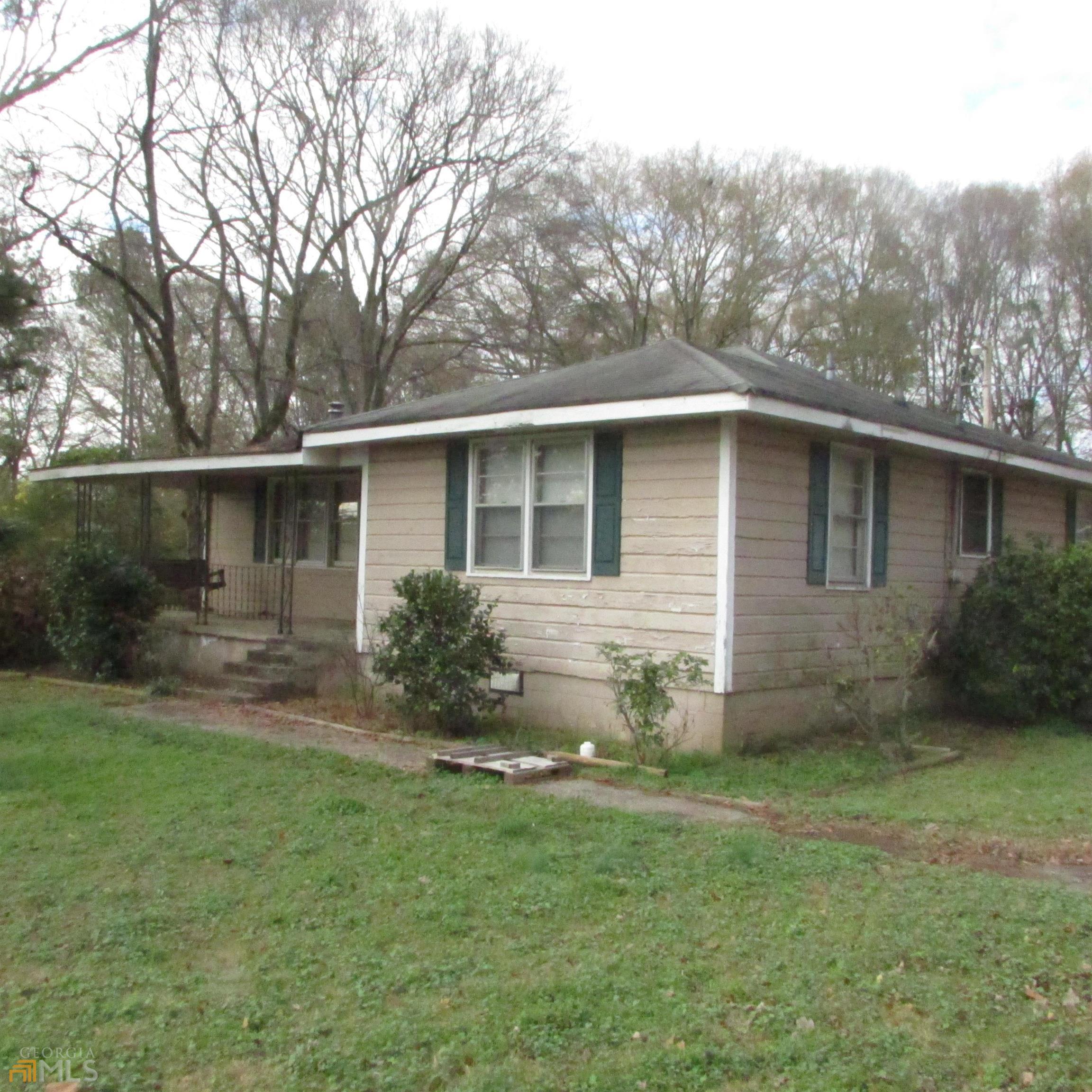 Bungalow minutes from growing Monroe, 2 large bedrooms with 1 full bath. This home can shine with your updating and renovations. Large family room. Home does not have central heat nor air. Very large lot for the right buyer to convert to a larger home. Garage in back has been converted to work room and 1 car garage. Enter via backdoor.