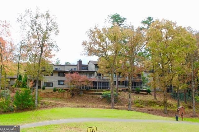 Enjoy the mountain life in this Spacious, comfortable and welcoming three bedroom main-level unit with view of golf course and surrounding mountains. Two master bedrooms and one guest bedroom help make this unit feel so spacious. The new French door helps to fill the great room with light while inviting you to enjoy the deck overlooking the mountains. This home has been tastefully upgraded and improved giving the country/rustic structure a bit of modern feel, using: New appliances, new floors, smooth ceilings, fresh paint throughout, kitchen and bathrooms all updated. The great room includes a dining area as well as a den area with stone fireplace and high end wood burning insert to provide warmth and efficiency. The chandelier with dimmer adds to the ambiance. This carefully thought out floor plan is ideal for full time residents but would also make a great get-away /second-home. You will find plenty of closet space and an attached storage unit. The numerous windows practically bring the manicured golf course and surrounding mountain views into the home. The large private pool is a nice place to spend the summer hours. Kings Point is conveniently located near Kingwood Country Club and a few miles from the restaurants and shopping of Clayton. There are plenty of hiking trails, river and lakes to explore in the North Georgia Mountains. Experience the convenience of one level living in the mountains.