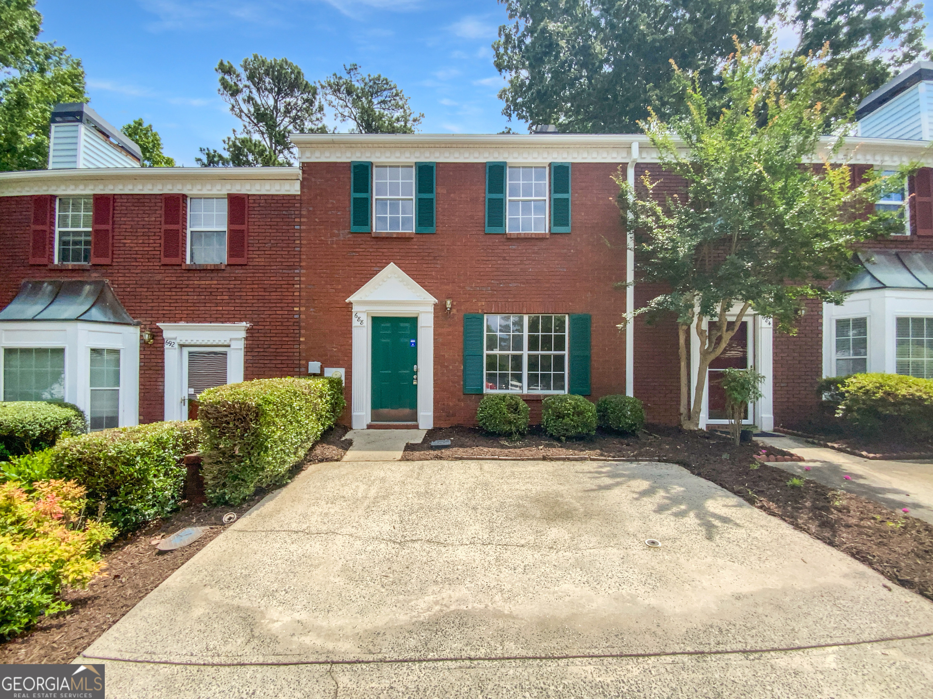 Welcome to this well-maintained and exceptionally clean two-bedroom townhome, offering a roommate floor plan for added privacy and comfort. Enjoy the inviting family room featuring a cozy fireplace, and a separate dining area accented by elegant French doors that open to a private deck-perfect for entertaining or relaxing while overlooking the fenced backyard. The kitchen boasts solid surface countertops, a pantry for extra storage, and a functional layout ideal for everyday living. Conveniently located just minutes from I-75, with easy access to shopping, dining, and more. Plus, enjoy the added bonus of a community pool for relaxation and recreation. Don't miss this wonderful opportunity-schedule your showing today!