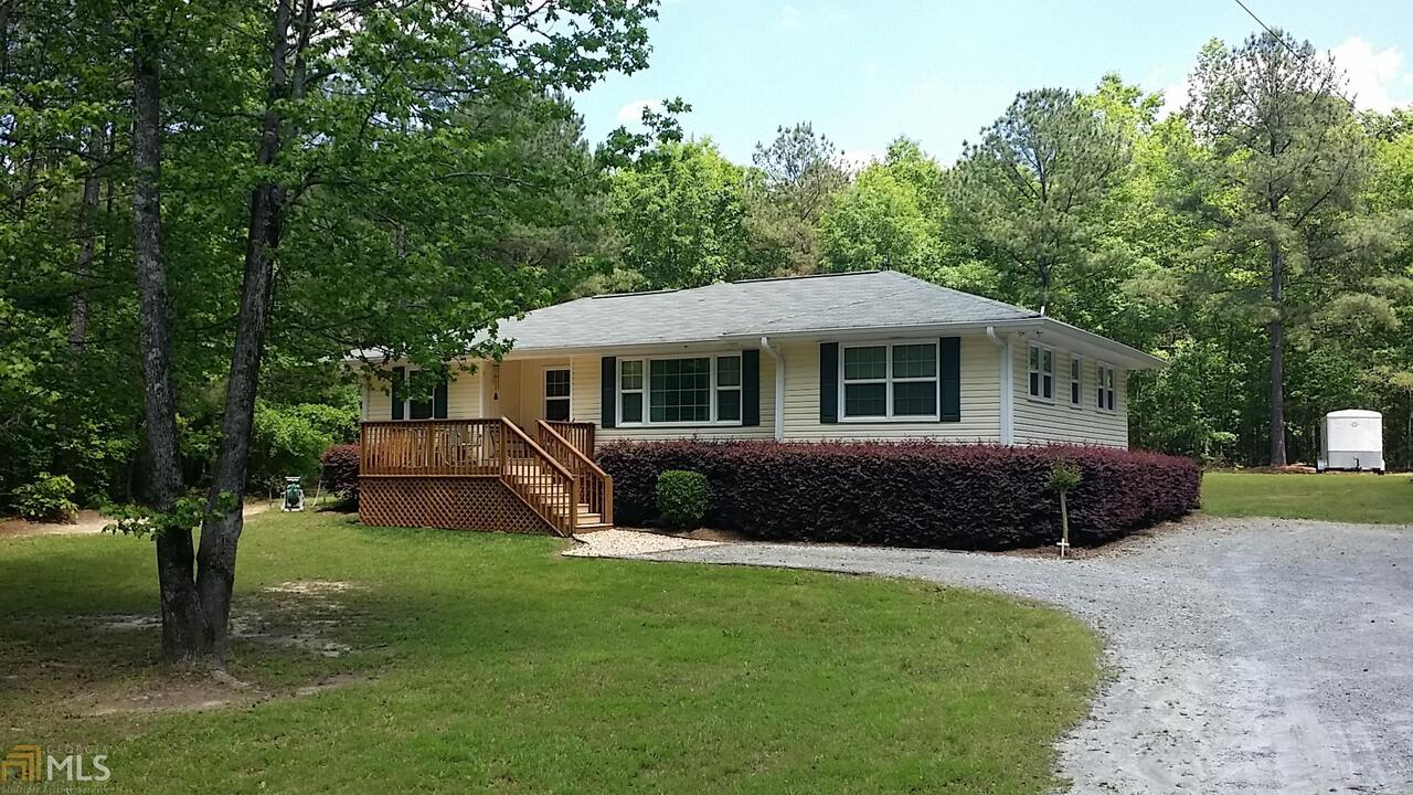 LOTS OF UPDATES TO THIS COUNTRY HOME. KITCHEN COUNTER TOPS, HOT WATER HEATER UNDER HOUSE, NEW AC UNIT. HARDWOOD FLOORS UNDER CARPET. HOME IS CONNECTED TO COUNTY WATER BUT ALSO HAS WORKING WELL. HOME HAS BACK DECK AND OUT BUILDINGS, ALL ON 3 ACRES. CLOSE TO BARNESVILLE, GRIFFIN AND INTERSTATE 75.