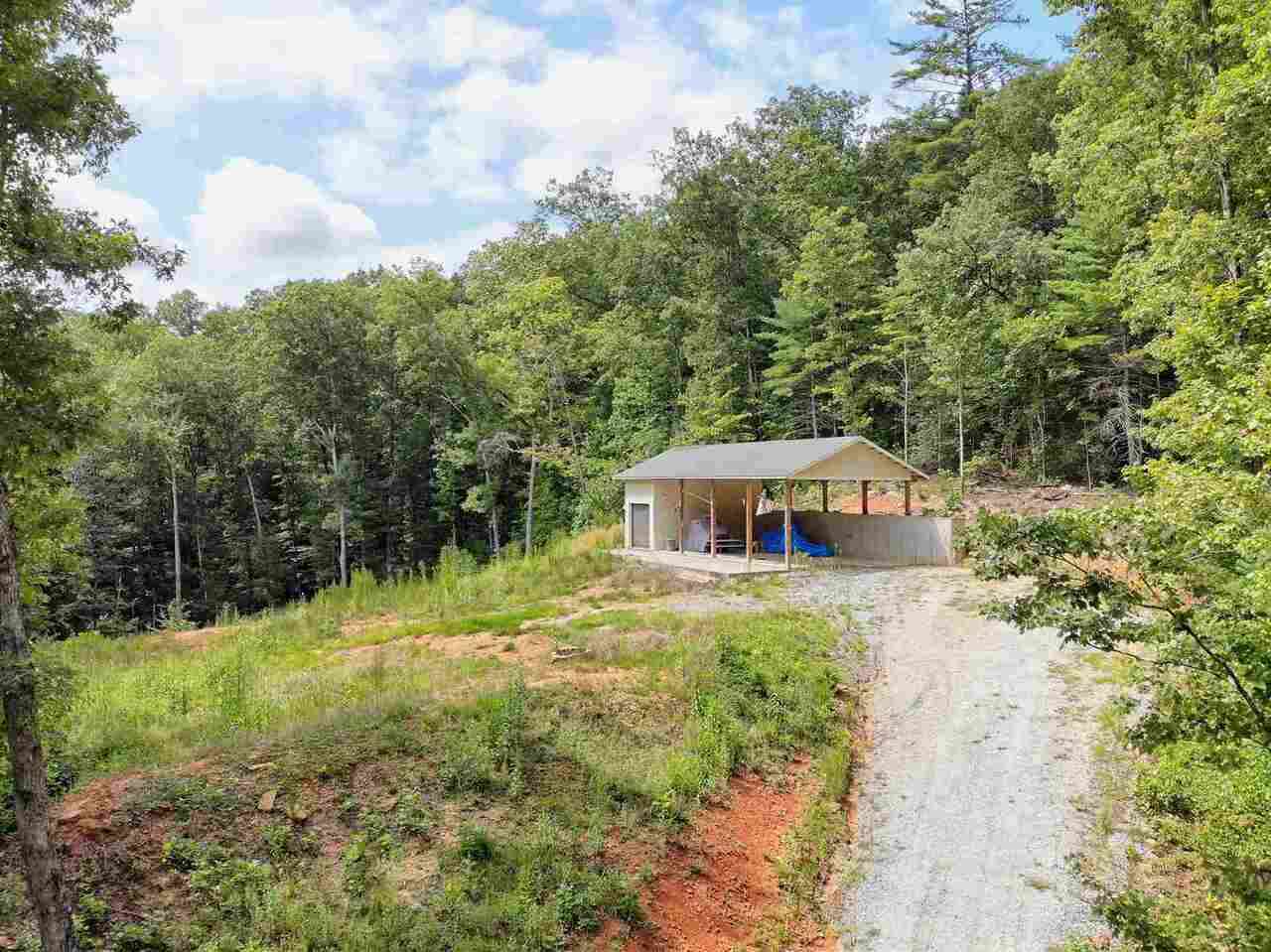 If your looking for a beautiful isolated property away from it all, this could be yours. This 25 acre property has a 60 x 25 building to park your RV under and build your dream home and a attached 12 x 26 workshop shop complete with a restroom. Water and Sewer is there. Pole Barn could be in closed for small home. This property has a well and a 3 bedroom septic tank already in place. Acreage comes with a small waterfall and a creek running through. Easy access off of Germany Mtn. Rd. Additional items included are Generac 22KW propane generator, and a 2017 Kioti 4x4 tractor with attachments. Looking for beautiful mountain land....come and get it!!!!
