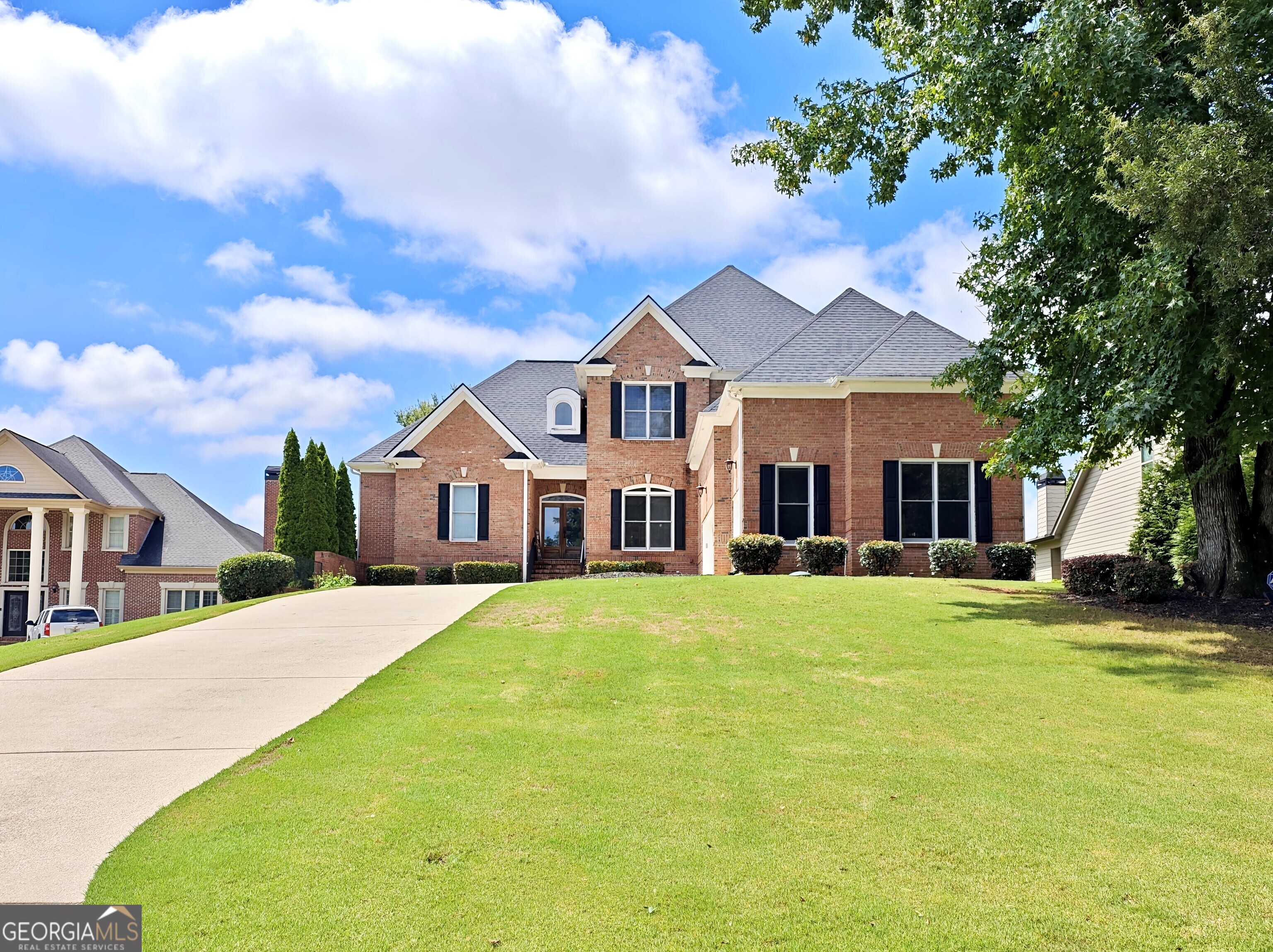 Welcome to this beautiful home in a highly desirable Country Club in The Traditions of Braselton! This very well-maintained home with 4 sided brick, in kid friendly cul-de-sac with a very large driveway with a large 3 car garage! Throughout the house you will notice heavy trim, large crown molding and large baseboards, many doors and windows that adds plenty of natural sunlight into the home. The main floor has 10 FT Ceilings, Master on main with its own HVAC unit. Also on the main floor an additional bedroom, another full bath, Large kitchen a laundry room! The upstairs has 9FT ceilings a 2nd living room/media area as you walk up the stairs, 3 additional bedrooms and 2 full bathrooms. Large basement with 9FT ceilings, and plenty of room to entertain! It has a full custom wet bar with custom shelves and cabinets, LED lighting, hardwood floors throughout, theater room, pool table area, game room for you to enjoy. Also in the basement a partially finished workshop area with double door entry from the side of the house. Many rooms have dimmer switches, remote dimming switches, intercom system, security system, DVR 16 camera system and LED Landscape lighting. Swim, tennis, golf, pickleball and playground in the community. Don't miss this opportunity to make this gem yours!