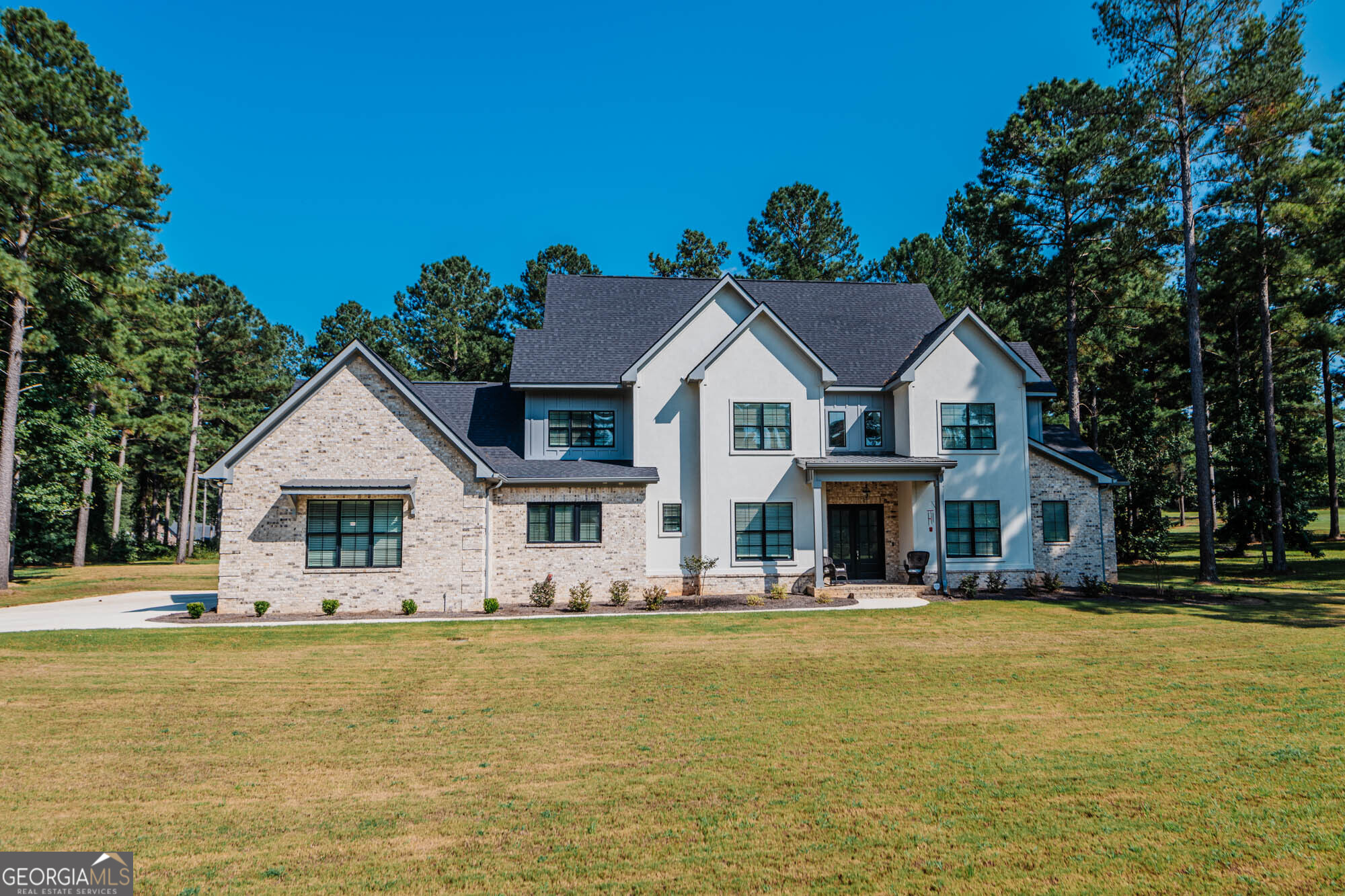 Welcome to Your Dream Home in Flat Creek Reserve! This stunning 5-bedroom, 4.5-bathroom home with a spacious bonus room offers approximately 4,085 sq. ft. of luxurious living space on a generous 2.60-acrelot. Step into an open floor plan designed for both comfort and entertaining. The chef's kitchen features a large island, granite countertops, GE Cafe appliances, double oven, and a spacious butler's pantry, along with a breakfast area and a formal dining room. The downstairs master suite includes two large walk-in closets, double vanity sinks, a relaxing garden tub, and an oversized tiled shower. Upstairs you will find a Jack-and-Jill bathroom and another full bathroom with additional bedrooms, providing ample space for family or guests. Additional highlights include: Gas fireplace in the living room, Oversized laundry room, Luxury vinyl plank flooring, plush carpet, and tile in wet areas, Oversized Covered patio with an outdoor cooking area, fireplace, and hot tub perfect for entertaining. Tankless hot water heater, gutters, and irrigation system. Endless outdoor enjoyment With thoughtful details and modern upgrades throughout, this home offers the perfect blend of elegance and functionality.