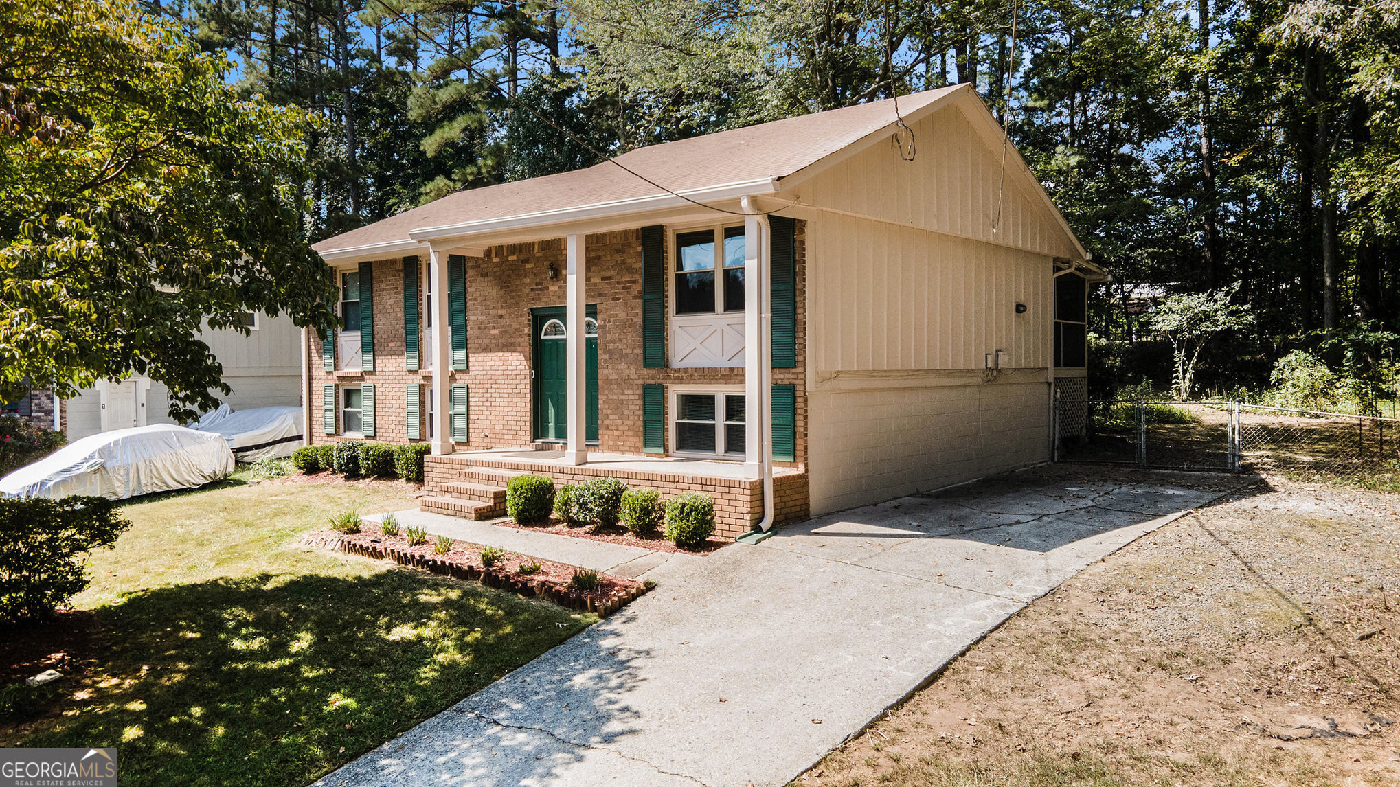 Welcome to this peaceful home stationed in the desirable Hollydale subdivision of Marietta, GA. This home offers both comfort and functionality, featuring a total of 3 bedrooms and 2.5 bathrooms, along with versatile spaces for everyday living and hobbies. The main level spans 1,107 square feet, offering a bright and welcoming layout. The kitchen has been tastefully renovated, featuring modern finishes and a fresh, clean design-perfect for meal prep and entertaining. The home also features fresh interior, as well as exterior paint! The main level includes 3 comfortable bedrooms, and 1.5 bathrooms, providing ample space for family or guests. Downstairs, you'll find a full basement, with 553 square feet of finished space, including a fully renovated full bathroom and a fireplace. The unfinished portion of the basement offers an excellent area for a workshop, hobbies, or extra storage, making it a flexible space to suit your needs. Step outside to enjoy the covered and screened-in deck, a perfect spot to relax and unwind while overlooking the fenced-in backyard. The sizable yard features a handy outbuilding, and even fruit-producing plants, including blueberries, adding a special touch to this outdoor retreat. Located in a well-established neighborhood, this home offers a wonderful balance of relaxing living spaces and charming outdoor features, with convenient access to schools, shopping, and local amenities! Whether you're looking for a comfortable family home or a property with versatile spaces, this Hollydale gem is ready to welcome you!