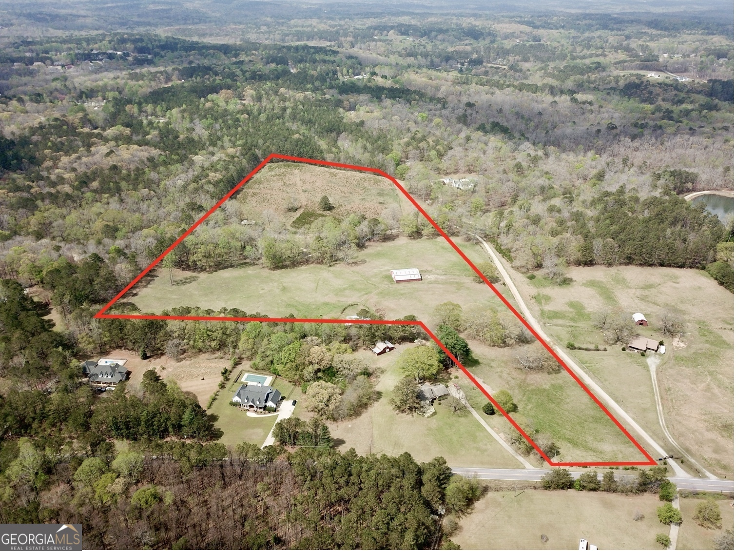 The Opportunity is zoned RA, Residential- Agriculture in Douglas County. The Site boasts 28 acres in pasture- with a mix of border timber- a strong network of trails- spring fed creek- and multiple property improvements. The Property improvements include a 4,800 sqft barn with utility and office area- fully fenced with cross fencing- a small riding arena- and a pole barn with covered stalls/ storage bins. When in operation the Site hosted 40 head of horses. The property was operated as a horse farm where the animals were breed and trained on site. The topography offers a rolling terrain with several additional building areas- multiple garden sites- and areas conducive to livestock and other recreational activity. The entire property is fenced. The Property offers over 2,500' of water frontage on Mobley Creek. The water feature is spring fed and offers a year round current with several sections of shoals and beach area. The Opportunity offers 137' of road frontage on Poole Mill Road.