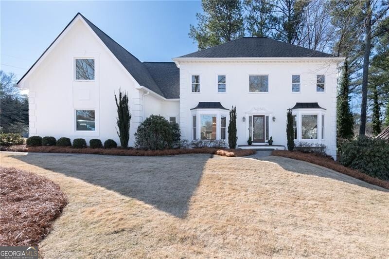 Welcome Home to this beautifully renovated East Cobb Executive Home that is situated on a well-manicured corner lot, nestled in a quiet cul-de-sac, providing exceptional curb appeal! This updated 4-bedroom, 3.5-bathroom home is truly move-in ready, offering a perfect blend of modern elegance, functionality, and prime location. Inside, the home has been thoughtfully updated with new carpet throughout and freshly painted interiors, creating a bright and inviting atmosphere. The renovated chef's kitchen showcases updated white cabinetry, stone countertops, stainless steel appliances, and high-end finishes that seamlessly flow into multiple spacious living areas-ideal for both daily living and entertaining. The family room incorporates a large fireplace surrounded by gorgeous library paneling chair railing, creating a warm and cozy atmosphere for family and friends. A full-sized dining room enriches the main level with plenty of seating for family and friends, holiday parties and game-days! A spacious home office/living room provides additional options for personal use! The oversized primary suite boasts a private fireside sitting room, creating a cozy private space for relaxing or reading! The large custom his-and-her closets and the fully updated en-suite bathroom featuring heated flooring, an expansive spa-like shower and soaking tub embody a true retreat. A finished basement adds incredible versatility, offering the perfect space for a home office, media room, fitness area, and workshop. The home is also equipped with energy-efficient double-pane windows, and a whole-house generator for added convenience and peace of mind, a new roof and gutters, along with too many other upgrades to list! The newly built deck extends the living space off of the kitchen as well as the family room, overlooking the beautifully landscaped private backyard, and provides the perfect setting for relaxation or entertaining. Located in a family-friendly community with swim and tennis amenities, this move-in ready home is just minutes from top-rated schools, shopping, and dining. This is a rare opportunity to own a meticulously maintained home in one of East Cobb's most desirable neighborhoods. Don't miss out-this one won't last!