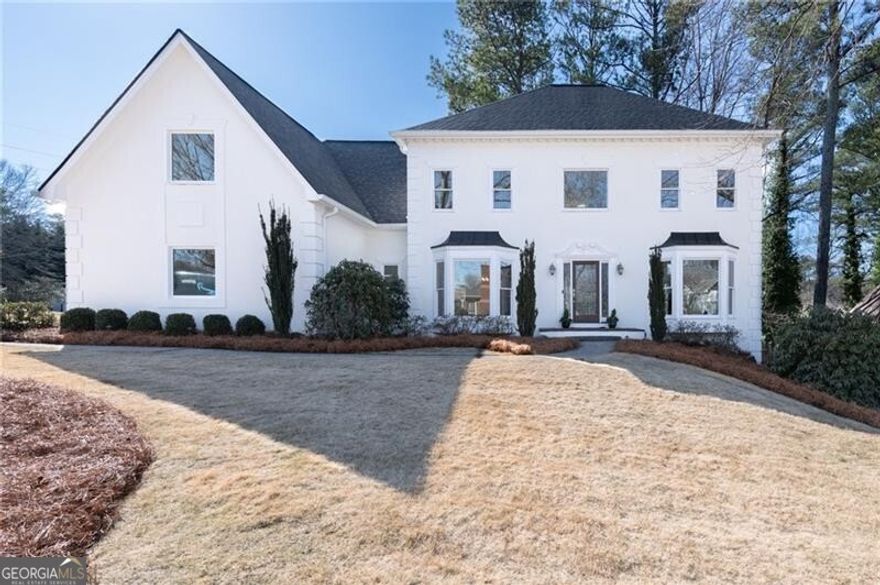 Welcome Home to this beautifully renovated East Cobb Executive Home that is situated on a well-manicured corner lot, nestled in a quiet cul-de-sac, providing exceptional curb appeal!  This updated 4-bedroom, 3.5-bathroom home is truly move-in ready, offering a perfect blend of modern elegance, functionality, and prime location.   Inside, the home has been thoughtfully updated with new carpet throughout and freshly painted interiors, creating a bright and inviting atmosphere. The renovated chef's kitchen showcases updated white cabinetry, stone countertops, stainless steel appliances, and high-end finishes that seamlessly flow into multiple spacious living areas-ideal for both daily living and entertaining.  The family room incorporates a large fireplace surrounded by gorgeous library paneling chair railing, creating a warm and cozy atmosphere for family and friends.  A full-sized dining room enriches the main level with plenty of seating for family and friends, holiday parties and game-days!  A spacious home office/living room provides additional options for personal use!   The oversized primary suite boasts a private fireside sitting room, creating a cozy private space for relaxing or reading! The large custom his-and-her closets and the fully updated en-suite bathroom featuring heated flooring, an expansive spa-like shower and soaking tub embody a true retreat. A finished basement adds incredible versatility, offering the perfect space for a home office, media room, fitness area, and workshop.   The home is also equipped with energy-efficient double-pane windows, and a whole-house generator for added convenience and peace of mind, a new roof and gutters, along with too many other upgrades to list! The newly built deck extends the living space off of the kitchen as well as the family room, overlooking the beautifully landscaped private backyard, and provides the perfect setting for relaxation or entertaining.   Located in a family-friendly community with swim and tennis amenities, this move-in ready home is just minutes from top-rated schools, shopping, and dining. This is a rare opportunity to own a meticulously maintained home in one of East Cobb's most desirable neighborhoods.  Don't miss out-this one won't last!