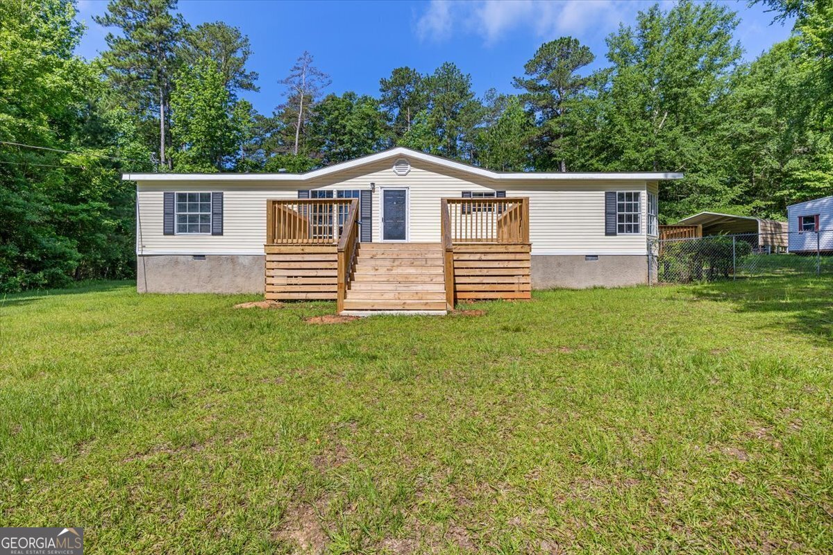 Discover lakeside perks without the lakeside price tag in this fully renovated 3-bedroom, 2-bath home located directly across the street from beautiful Lake Sinclair at 165 Forest Hill Drive in Eatonton, GA. On a quiet dead end road, enjoy lake views, community access, and a convenient boat ramp for a small yearly fee-perfect for weekends on the water. This 1,568 sq ft home sits on a spacious 1.01-acre lot and features fresh LVP flooring, new carpet, updated cabinets and countertops, a large soaker tub, a walk-in shower, and brand-new appliances. The exterior shines with new front and back porches, a fenced in backyard with a drive-through gate, a metal carport, two sheds (one fully wired), and all-new paint, roofing, and HVAC. With a modern interior and serene setting, this move-in-ready gem offers the perfect blend of comfort, convenience, and lake lifestyle. Call today to schedule your showing and lets get you sold on lakeside living!
