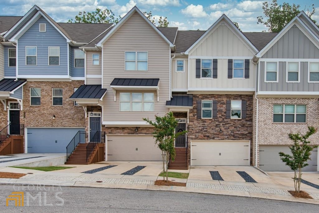 For Lease - Spacious 3BR/3.5BA Townhome with 2-Car Garage & Finished Basement! This beautifully maintained townhouse, built in 2019, features an open-concept main level with a spacious family room, eat-in kitchen with stone countertops, breakfast bar, and a private back deck with serene wooded views. A convenient half bath completes the main floor. Upstairs offers two oversized master suites with tray ceilings, large vanities, walk-in closets, and en-suite baths featuring separate tubs and stand-up showers - ideal for families or roommates. The finished terrace level includes a third bedroom with full bath and closet-perfect for guests or a home office. Washer and dryer included. Landlord covers: HOA dues, landscaping, and termite service. Tenant responsible for: Water, trash, and electric (no gas). Outstanding location-walk to the high school, less than a mile to I-985 and UNG Gainesville campus. Just minutes from Lake Lanier, downtown Flowery Branch & Gainesville, local nature centers, walking trails, and plenty of shopping and dining options. Dog park located in the neighborhood. Don't miss this rare rental opportunity in a prime area!