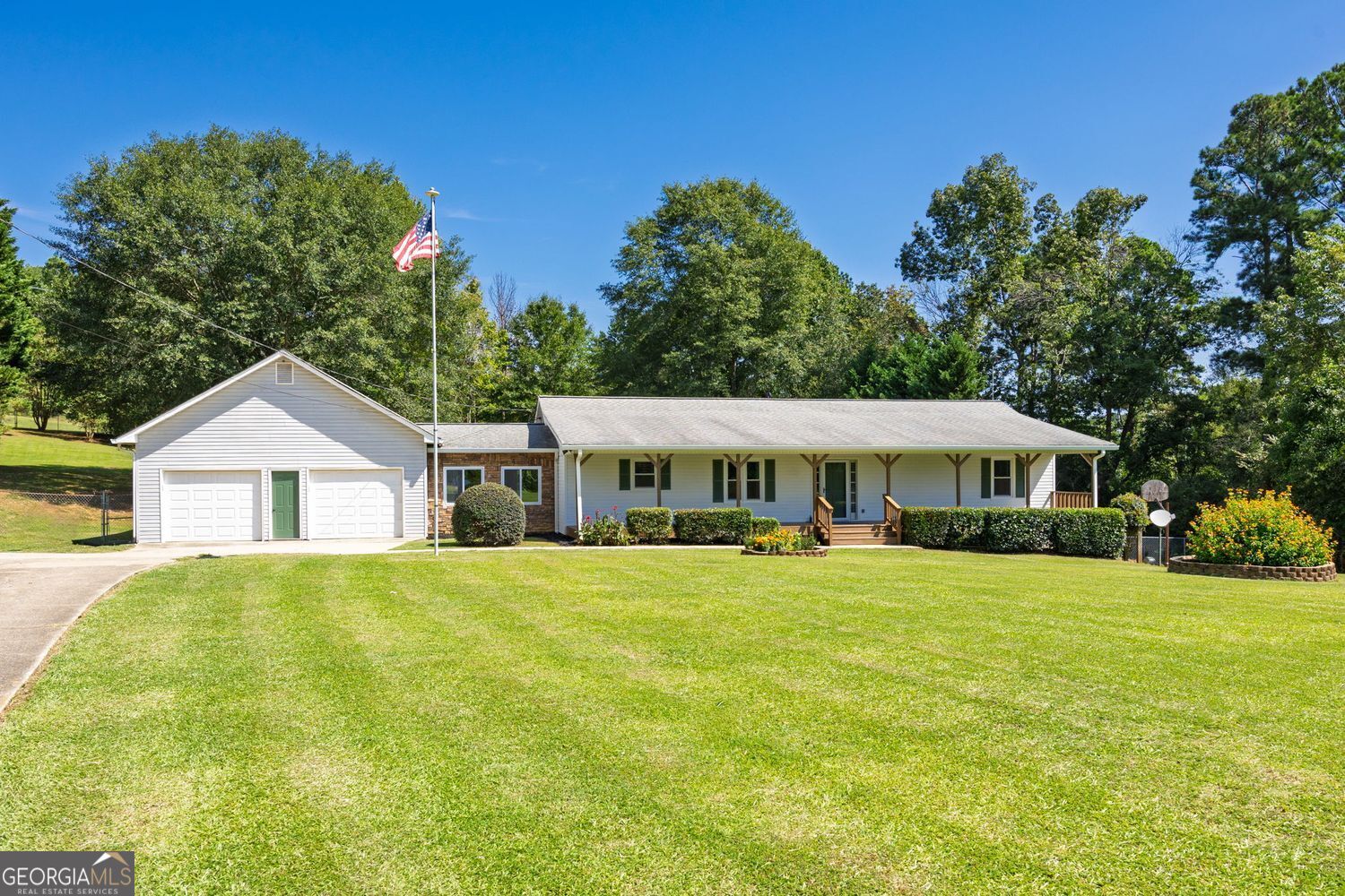 Welcome to your dream home, nestled on 4.33 private acres! This well-maintained ranch-style home boasts a beautiful 8' x 56' covered front porch in a peaceful setting with occasional wildlife visitors. A large screened-in back porch provides the perfect space for entertaining or relaxing while enjoying the soothing sounds of nature. Inside, you'll find a spacious eat-in kitchen with oak cabinets and all appliances, including the refrigerator. The master bedroom features his-and-hers closets, and the updated master bath is stunning with an oversized tiled shower, marble countertops, and a double vanity set on a slip-resistant tiled floor. The two secondary bedrooms are generously sized, each with a walk-in closet, offering comfort for family or guests. A mudroom connects the garage to the home, adding versatile potential-ideal for a home office, utility area, or creative space. It also offers easy access to the one-acre fenced backyard, perfect for pets or children. The additional acreage provides endless opportunities for recreation, gardening, or future expansion. The expansive garage is another standout feature, complete with workbenches, attic storage, and ample room for hobbies, tools, and vehicles. Its spaciousness is sure to impress. Located in the highly sought-after North Paulding School District, this must-see home is within a 20-minute drive of Dallas, Rockmart, Cartersville, Acworth, and Hiram. You'll also enjoy easy access to the Silver Comet walking and biking trail, Red Top Mountain State Park, and Lake Allatoona. This home combines peaceful living with the convenience of nearby amenities. Don't miss the opportunity to fall in love with this charming ranch-style home that offers plenty of breathing room and elbow space!