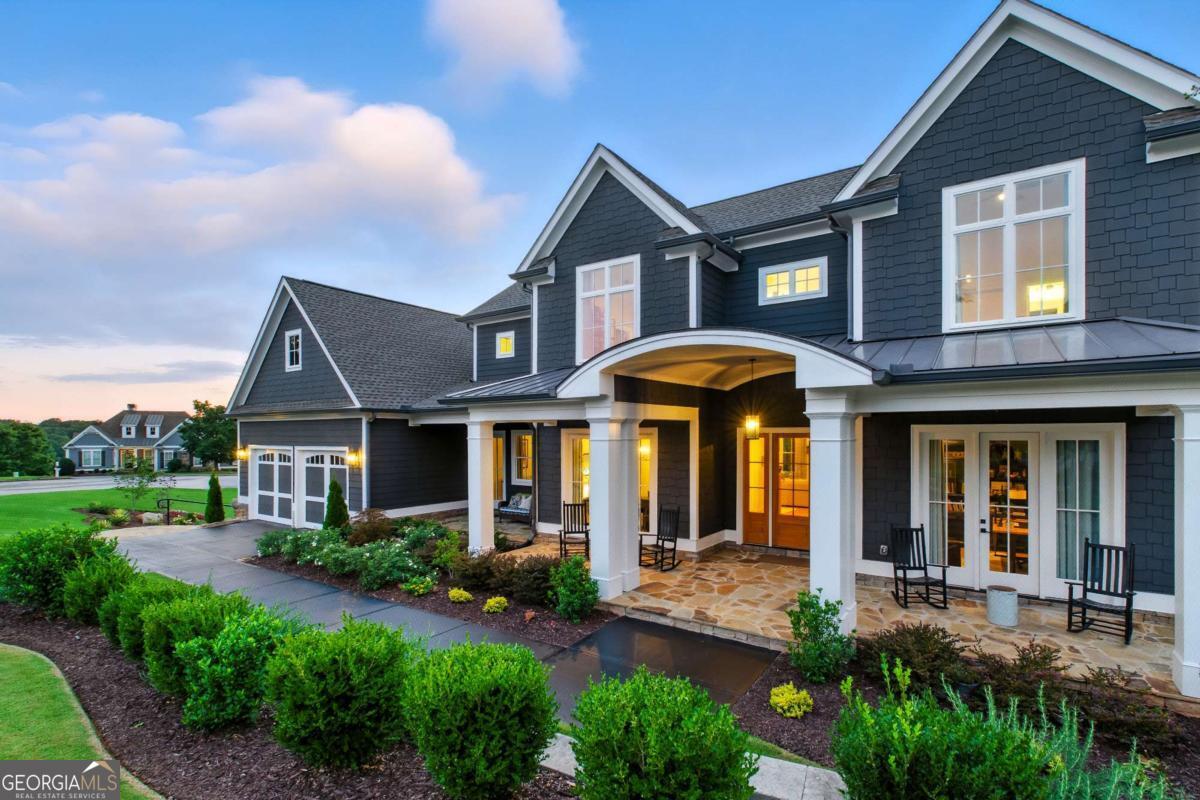 Welcome to the Chestatee Lake and Golf Community where this exquisite home at 9 Fieldstone harmonizes classic architecture with resort-style living in the heart of North Georgia's most coveted neighborhood. Nestled within a master-planned, lake-and-golf community, the home stands as a testament to custom design and thoughtful craftsmanship. This property is better than new, custom built sanctuary by Wolf Creek Homes exceeding all expectations from the moment you arrive. The stately curb appeal sets the tone- this is luxury made personal. Step inside through the beautifully stained wooden front door, framed by a covered, flagstone patio and discover a grand foyer with a formal dining room to your left and a private office to your right- both dining area and office feature French doors leading to the covered, front patio. Enter the living area and find a grand wall of windows, offering a stunning panorama of rolling golf fairways and lush landscape beyond. The open floor plan captivates at every turn, balanced effortlessly with intimate spaces for relaxation and celebration alike. The expansive living room is centered around a painted-brick fireplace and anchored by picture windows framing course views-the perfect setting for gatherings. Stunning wide planked White Oak floors and 10'- 12' ceilings throughout the home sets this home apart from the rest! The gourmet kitchen is an entertainer's delight! Perfect for hosting, the kitchen is appointed with top-tier appliances: 36" KitchenAid Dual Fuel Commercial slide in range, KitchenAid dishwasher, commercial grade refrigerator, and a sleek SHARP microwave drawer. Morning coffee or evening wine flows effortlessly thanks to the keeping area / breakfast room, a wet bar with beverage center, and a dedicated friends' entrance. The home's aesthetic is anchored by wide-plank white oak flooring and 10'-12' foot ceilings accented with shiplap-every detail thoughtfully refined. Outdoor living is equally stunning! Enjoy a covered, screened-in back porch leading down to the plush emerald zoysia grass back yard and dried-in flagstone patio with a large, outdoor fireplace overlooking the golf course. A full unfinished, daylight basement with matching, high ceilings to the main floor provides abundant storage or potential for future expansion. The garage includes durable, epoxy finished floors and accommodates two full sized vehicles and a golf cart. Live the resort lifestyle within Chestatee! Residents savor the finest in resort-style amenities daily-where weekends truly never end. Highlights include: award-winning 18-hole championship golf course designed by Denis Griffiths- set amid rolling hills and scenic mountain views, an elegant clubhouse offering fine dining and social gatherings, the Nightfire Lodge-ideal for community events, a Junior Olympic-size pool, children's splash area, playground, sports and bocce court, a lakeside pavilion with a grand stacked stone fireplace-perfect for gatherings or roasting marshmallows, a private marina with boat slips on Lake Lanier, plus miles of lakeside walking and biking trails, and a vibrant community square with bandstand- offering social events and pastoral charm. Step inside 9 Fieldstone and be wowed-from the front patio to the back porch, from sweeping views to intimate details. This is where craftsmanship meets lifestyle; where every day feels like a retreat.