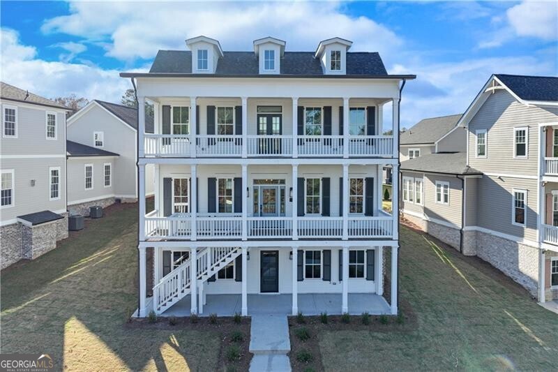 **Special Financing Available **One of the distinctive "Six Sisters" at Homestead at Hog Mountain, this charming property was crafted by one of our preferred architects, Alison Ramsey, drawing inspiration from San Francisco's iconic "Painted Ladies". This adaptable plan, artfully designed for versatility, boasts 5 bedrooms and 5.5 bathrooms, and is gracefully spread across three levels of living space. Highlights include an open kitchen with a central island and dining area, a cozy study or office complete with a fireplace, a bright and airy sunroom, and a spacious family/media room equipped with a built-in kitchenette. Additionally, with its own entrance, the lower level offers private access and encompasses 2 bedrooms, 2 bathrooms and the family/media room with kitchenette. Along with the unfinished ADU space above the garage, this thoughtfully crafted layout allows the home to adapt to your needs and provides an ideal haven for multigenerational living options.