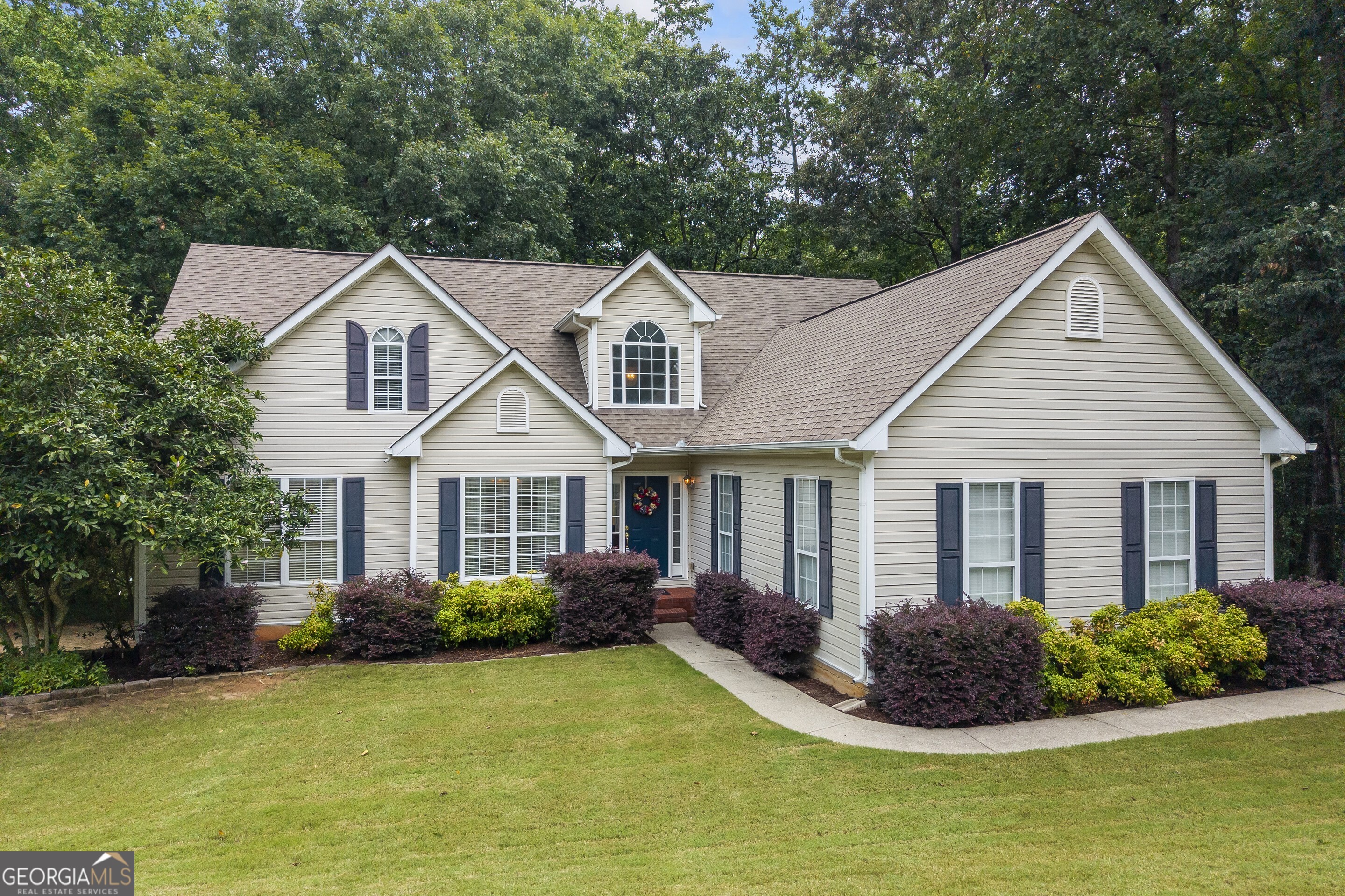 Welcome to your new home in the highly sought-after Hamilton Mill Parc neighborhood. Nestled on over 2 private acres, this home offers space, comfort, and versatility across 3 levels. The main level features a split bedroom floor plan with 3 bedrooms and 2 fully baths, providing privacy and ease of living. The primary ensuite offers 2 separate walk-in closets, double vanities in the bathroom with separate tub and shower. The heart of the house boasts a modern kitchen with granite countertops, and updated appliances, perfect for entertaining or quiet family dinners. Upstairs, you'll find a bonus room or 5th bedroom complete with a half bath, ideal for a home office, guest suite, or playroom. The finished terrace level offers interior and exterior access and is a true extension of the living space - complete with a game area, kitchenette, TV/lounge area, bedroom, full bath, and even a workshop with its own private entry. Enjoy the serenity of the private, wooded backyard, perfect for relaxing entertaining, or enjoying nature's quiet beauty. This exceptional home combines the best of location, layout and lot!