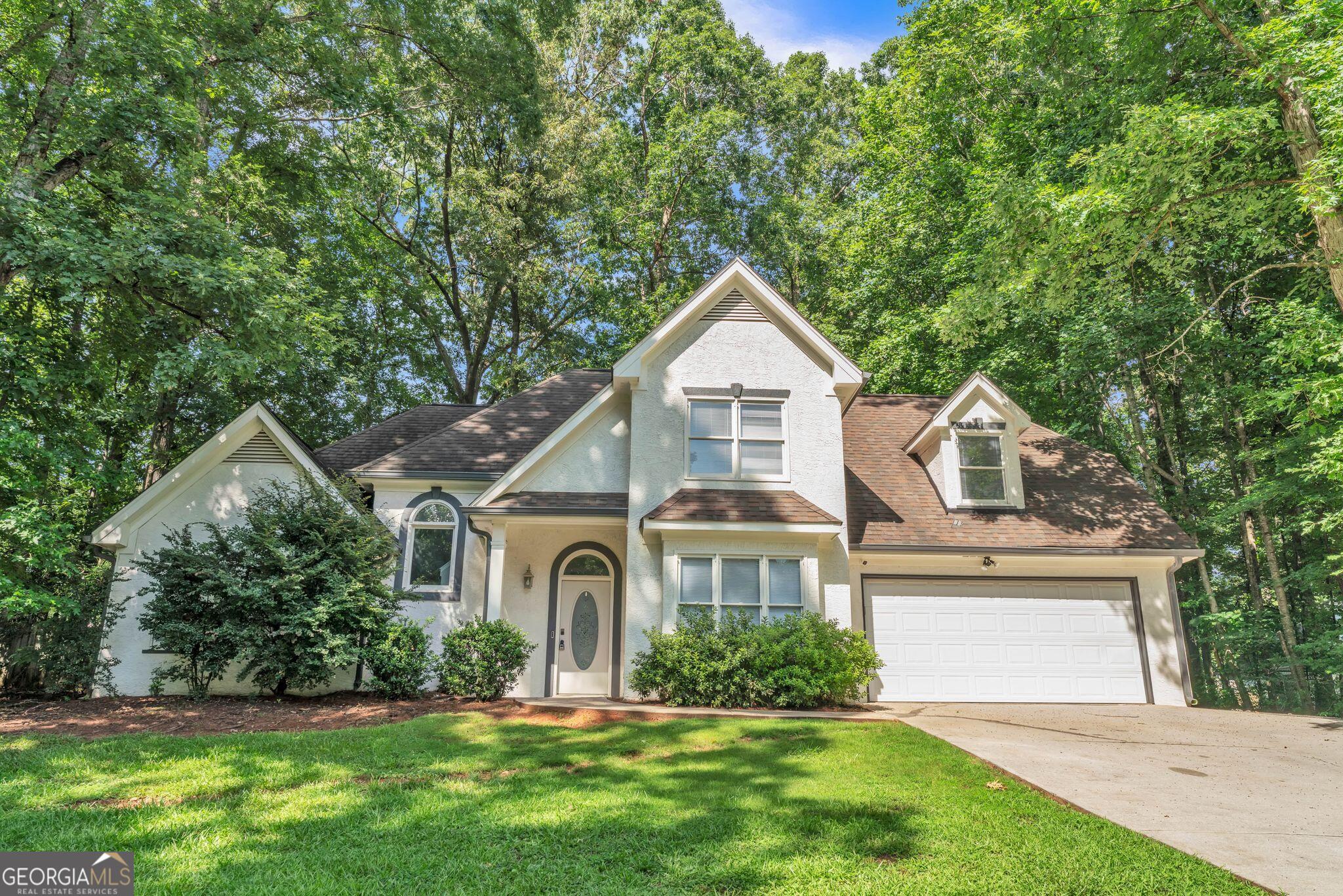 Welcome to 105 Rosewood Circle, a well-kept 4-bed, 2.5-bath home in the quiet Woodstone subdivision. Freshly painted throughout, this home features a spacious main-level master suite, vaulted ceilings, and a cozy gas fireplace in the living room. The kitchen offers granite countertops, stainless steel appliances, and an eat-in area overlooking the fenced backyard. A separate dining room, upstairs bedrooms, and a convenient laundry/mud room add function and comfort. Residents enjoy access to a community pool and tennis court. Set on nearly half an acre, this home is clean, move-in ready, and full of charm.