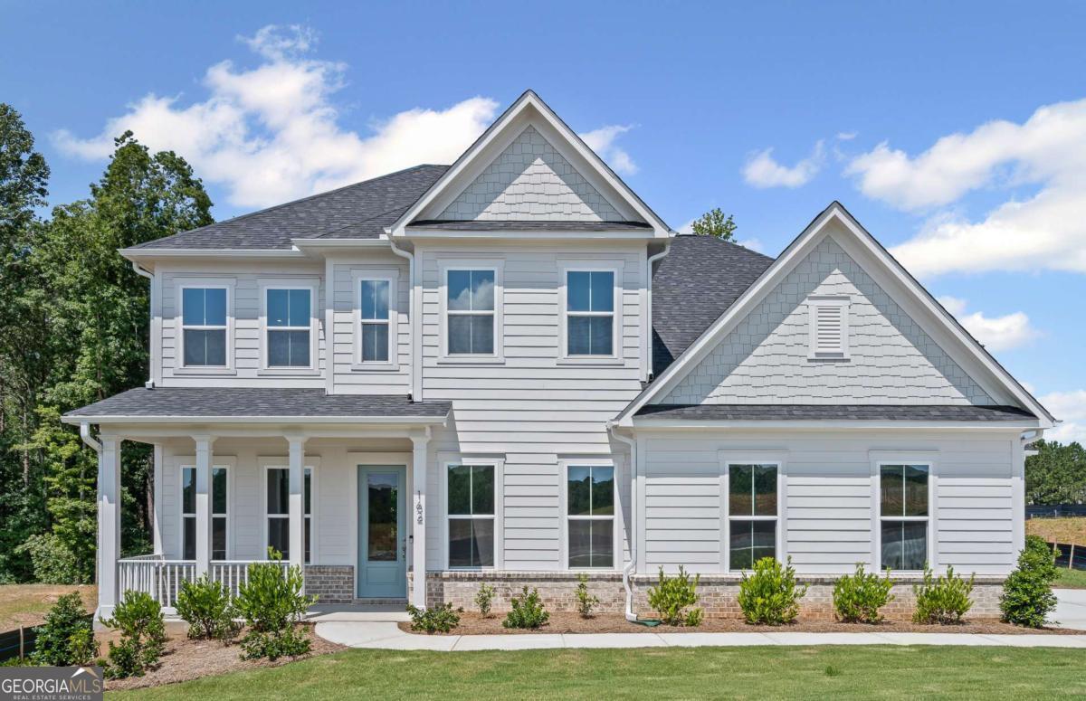 Welcome to luxury living in Traditions of Braselton - the ONLY Golf Cart Friendly community in Jackson County surrounded by a private golf course and on-site private restaurant! This stunning Riverton model offers over 3,100 sq ft of thoughtfully designed space on a spacious 1/3-acre homesite. Enjoy a 3-car garage, a guest suite on the main level, a private library/study, and a cozy fireplace in the open-concept family gathering area. The beautifully laid gourmet kitchen features built-in appliances and flows seamlessly to a covered lanai-creating an additional outdoor living space to entertain or relax. Upstairs, you'll find 4 generously sized bedrooms, including a serene owner's suite, plus a versatile loft for extra family living. Traditions of Braselton is truly resort-style living you can come home to! Additional amenities include a Jr. Olympic-sized pool, 6 lighted tennis and pickleball courts, 24/7 fitness center and yoga studio, walking trails, and stocked fishing ponds. Experience refined living in one of Jackson County's most desirable neighborhoods with Top Rated Schools!