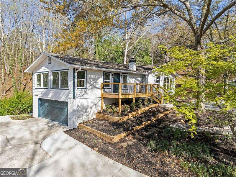 Imagine waking up to breathtaking seasonal views of Lake Lanier from your charming front porch, sipping coffee as the morning sun dances across the water. This fully renovated ranch seamlessly blends modern luxury with the warmth of lake living. Inside, an open-concept design welcomes you with flowing luxury vinyl plank flooring, a sun-filled living and dining area, and a designer kitchen boasting white cabinetry, gleaming granite countertops, stainless steel appliances, and an oversized island perfect for entertaining. Retreat to the serene master suite, where a freestanding soaking tub and tiled shower create a spa-like escape. With four bedrooms on the main level-one doubling as a sunroom-and a versatile bonus room for a home office, there's space for every need. The finished basement offers even more flexibility, featuring a second living area, a private bedroom, and a full bath-ideal for guests or a lucrative short-term rental. Just minutes from Lake Lanier's boat ramps, top golf courses, vibrant dining, and the North Georgia Outlets, this home is a rare find in a prime location. Whether you're searching for the perfect vacation retreat or an income-producing investment, this is lake living at its finest-don't miss out!
