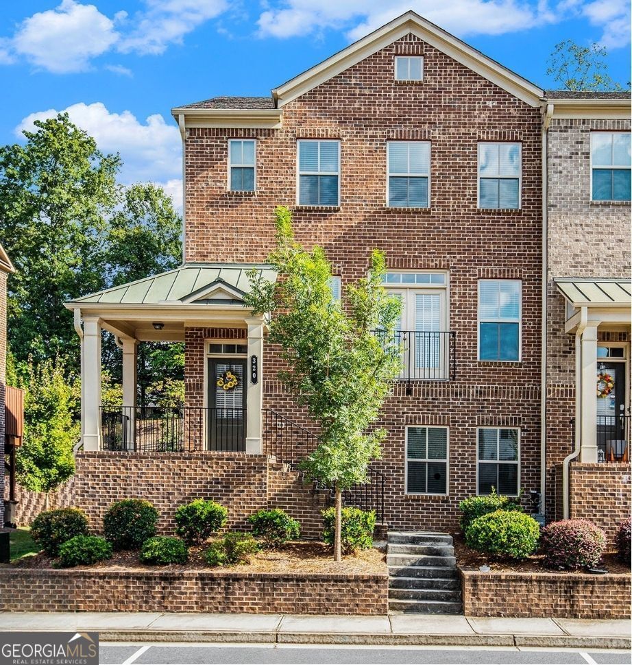 Welcome Home- this is a must see! A spacious 3-level End-unit, all brick townhome with a finished basement; nestled in the heart of Suwanee. From the moment you enter; you'll step into an open, light-filled main level with hardwood floors and a great flow between the living, dining, and kitchen areas. The gourmet kitchen features stainless steel appliances with a 36" gas cooktop, single wall oven and built-in microwave. Also boasts granite countertops, an island with seating, and lots of cabinet space - perfect for everyday living or entertaining. Adjacent to the living space is a half bath and the family room offers built-in bookshelves. Adjacent to the kitchen is a cozy dining area that offers ample space for family gatherings, flowing effortlessly into the living room. With multiple lighting options, you can set the perfect ambiance for any occasion. The staircase, adorned with decorative railings, guides you to the upper levels where you will discover well-appointed bedrooms. You'll find two comfortable bedrooms with generous walk-in closets, well-lit with natural sunlight and a convenient upstairs laundry. The Owners suite offers its own private bathroom with a double vanity, garden tub, separate shower and a large walk-in closet with a custom-built racking system, creating a private retreat. The finished basement adds even more flexibility with an additional bedroom. Whether you need space for a home office, media room, or guest suite, you will enjoy the privacy! This spacious end-unit townhome allows you to enjoy a private deck surrounded by greenery, ideal for relaxing or hosting friends. The community is close to I-85, shopping, dining, and major conveniences, so everything you need is nearby. If you're looking for a move-in ready home that combines a beautiful modern space, elegant style, comfortable living and a great location in Suwanee, this one is worth a look. Schedule your private showing today!