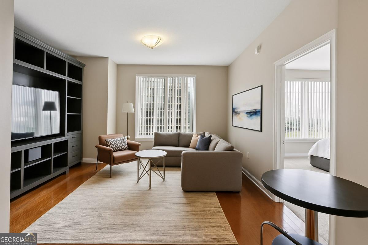 Experience upscale city living in this beautifully updated one-bedroom, one-bathroom condo at the iconic Museum Tower in Downtown Atlanta. This spacious residence is perfect as a full-time home or stylish pied-a-terre with breathtaking views of Centennial Olympic Park and Mercedes-Benz Stadium. The unit is available unfurnished or fully furnished at a lease rate of $2,095.00 per month, offering flexibility to suit your lifestyle. The interior features a bright, open layout with recent upgrades including a frameless glass shower with quartz tile caps, freshly painted bathroom cabinetry and hardware, new recessed lighting, an LED vanity mirror, and elegant pendant lighting above the whirlpool tub. The kitchen is outfitted with refinished cabinetry, updated hardware, and sleek countertops. Enjoy the convenience of in-town living just steps from State Farm Arena, Bobby Dodd Stadium, Georgia Tech, Georgia State, AmericasMart, and many of Atlanta's top dining, shopping, and entertainment destinations. Museum Tower provides exceptional amenities including 24-hour concierge, a rooftop pool, gym, clubroom, conference room, outdoor plaza with lounge seating, grilling stations, a dog walk area, and a guest suite. Lease includes assigned secure parking, high-speed internet, and basic cable, making this a turnkey opportunity for luxury living in the heart of the city.