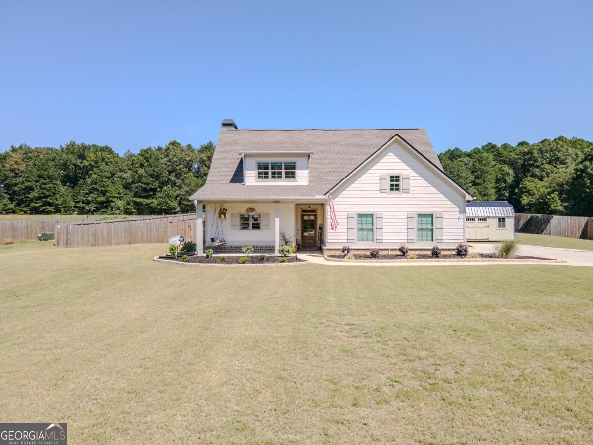 Welcome to this nearly new home in the heart of Monroe, offering a perfect balance of comfort and style. From the moment you arrive, the curb appeal shines with a welcoming covered front porch and a spacious yard ideal for outdoor enjoyment. Step inside to find an open floor plan designed for both everyday living and entertaining. The kitchen is a showstopper with its custom backsplash, sleek cabinetry, and generous island seating that flows seamlessly into the dining and living areas. The main-level owner's suite provides a private retreat with a spa-inspired bathroom featuring dual vanities, a walk-in shower, and elevated finishes. Secondary bedrooms are oversized, with one offering its own private large bathroom, creating flexibility for guests or multi-generational living. The upstairs media and bonus space adds even more room to spread out, whether for movie nights or hobbies. Outdoors, the brand-new 16x36 resort-style pool is the highlight of the property. With an 8-foot deep end, tanning ledge with bubblers, LED lighting, and custom concrete surround, it's designed for both relaxation and recreation. The expansive 2-acre lot provides plenty of room for play, gardening, or simply enjoying the peaceful backdrop. All of this is just a quick golf cart ride to historic downtown Monroe, with its vibrant shops, dining, and community events. This home blends quality upgrades, outdoor living, and a prime location-an incredible opportunity you won't want to miss.