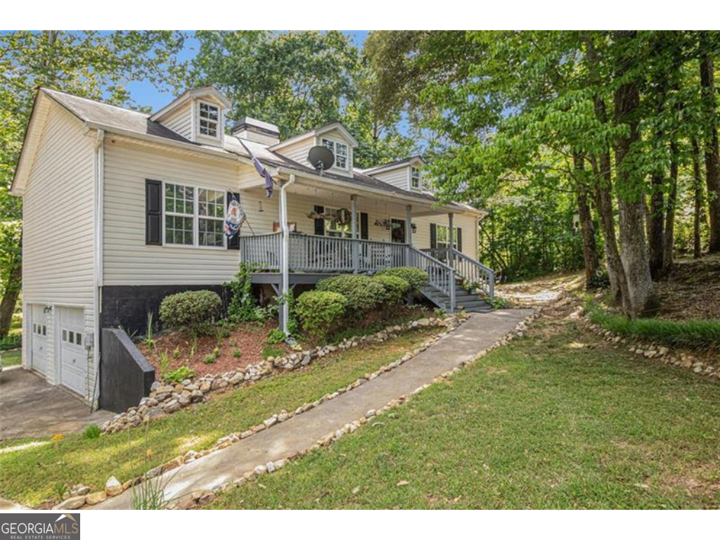 This home offers eclectic charm with a primary suite on the main level, providing an easy-living lifestyle in a private cul-de-sac with no neighbors in sight. With 4 bedrooms and 3 bathrooms, this home provides ample space for the family. The first floor boasts 18-foot ceilings and includes 3 bedrooms and 2 full bathrooms. The basement features a finished family room, an additional bedroom, a full bathroom, and an office space - perfect for privacy or work-from-home needs. Spanning a generous living space on over a half-acre lot, this home is located near the best of Temple, GA. Enjoy the peaceful outdoors from the deck overlooking a small stream that flows through the property, offering tranquility and nature at your doorstep. Relax on the inviting rocking chair front porch while enjoying the quiet surroundings. Please note that this home features all-electric appliances (there is no gas service), and the fireplace is fueled by wooden logs. The stove and refrigerator are not included with the sale but may be available for purchase. With its vaulted ceilings, spacious rooms, and beautiful outdoor setting, this home is a must-see. It won't last long!