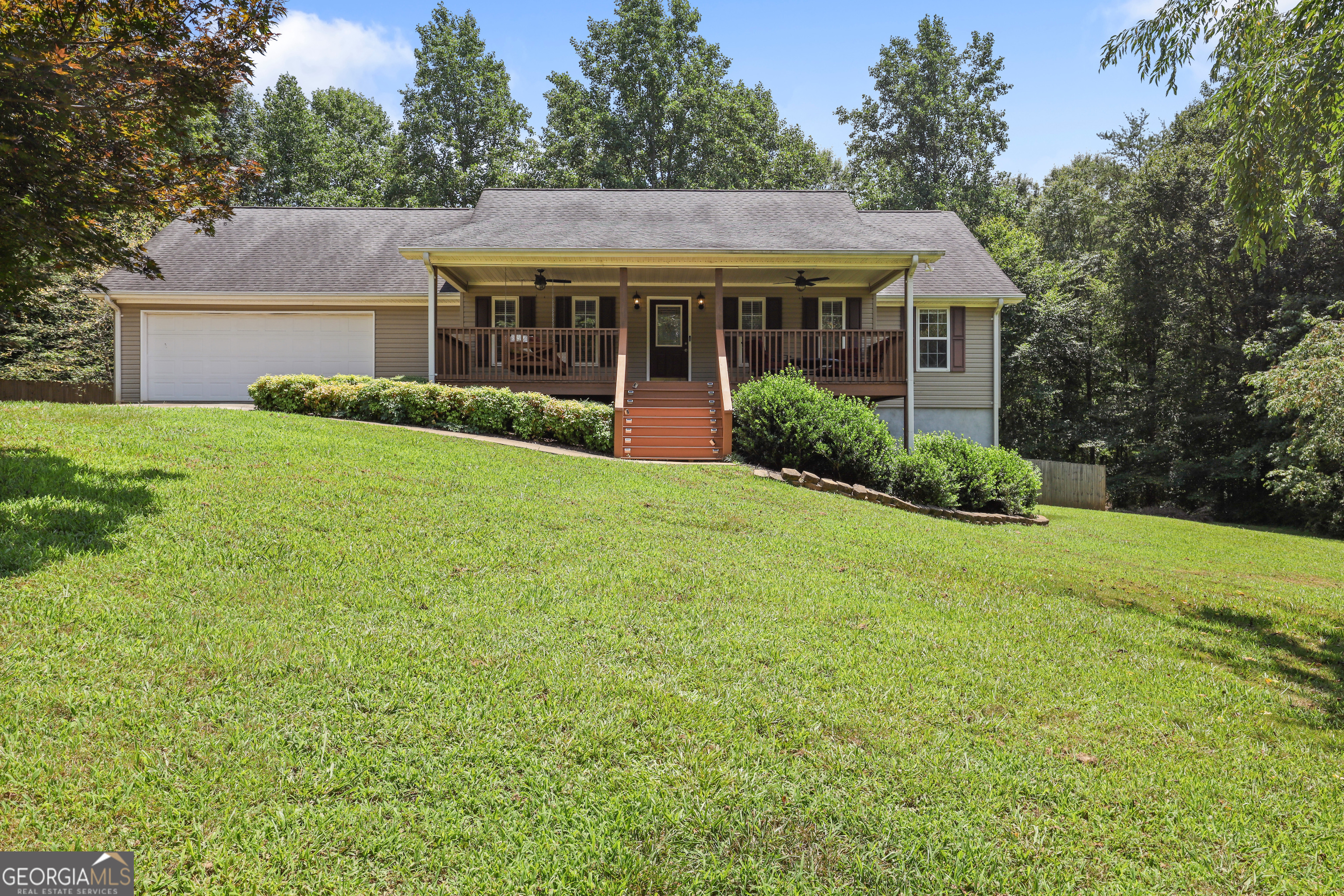Creekfront Retreat with Versatile Living Space! Welcome home to this spacious creekfront beauty, perfectly tucked away on a quiet cul-de-sac yet convenient to Historic Clarkesville and Tallulah Falls. This thoughtfully designed 5-bedroom home offers room for everyone - plus flexible spaces to suit your lifestyle. Step inside to find a welcoming foyer that opens to a dedicated office and formal dining room. The expansive kitchen features ample counter space and flows seamlessly into the light-filled living room with vaulted ceilings - ideal for gatherings with family and friends. Relax in the luxurious main-level primary suite, complete with an oversized walk-in tiled shower, dual vanities, and an impressive walk-in closet. Three additional spacious guest bedrooms are located on the main level, offering comfort and privacy for family or visitors. The terrace level provides even more living options with a finished additional master suite, full bath, and closet, plus a bonus room perfect for a personal gym, media room, or extra office. An open area is ready for you to finish with your personal touch - create the ultimate game room, workshop, or hobby space! Enjoy outdoor living year-round with a full covered front porch and back deck overlooking a beautifully landscaped backyard. The walk-out basement leads to a private patio inside a fully fenced backyard - just steps away, a short trail takes you down to your own serene creek frontage. This special home combines privacy, space, and nature, all within minutes of local dining, shopping, and outdoor adventures. Septic Permit for 4 bedrooms. 5th bedroom in terrace level finished after seller purchased home.