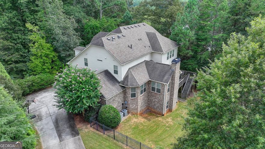 Elegant Living in The Oaks on Charlotte Drive - Welcome to 910 Reece Road, a beautifully designed 6-bedroom, 5-bathroom residence set on nearly an acre of wooded privacy in one of Alpharetta's most desirable communities. Built in 2012, this thoughtfully crafted home combines timeless elegance with modern comfort, making it ideal for both everyday living and entertaining.    Step inside and discover a flowing floor plan filled with natural light and designer finishes. The main level features a warm and inviting family room with fireplace, a formal dining area for gatherings, and a guest bedroom with full bath-perfect for hosting family and friends. The heart of the home is the stunning kitchen, complete with an oversized island, abundant cabinetry, and premium appliances. A seamless connection to the breakfast area, keeping room, and deck makes this space the hub of daily life.    Upstairs, the spacious primary suite offers a peaceful retreat with a spa-like bathroom and generous walk-in closet. Three additional bedrooms and two full baths provide plenty of room for everyone.  The finished terrace level expands the living space with multiple areas for recreation, a media room, or even a home gym-designed to adapt to your lifestyle needs.    Outdoors, enjoy the wooded backdrop from the expansive deck, creating the perfect setting for relaxation or entertaining. A three-car garage and nearly one acre of property provide both practicality and privacy, with ample space for a future pool if desired.    Located in The Oaks on Charlotte Drive, this home offers unmatched convenience. Top-rated schools-Crabapple Crossing Elementary, Northwestern Middle, and Milton High-are just minutes away, along with the shopping, dining, and entertainment of Crabapple, Downtown Alpharetta, and Avalon.  910 Reece Road is a rare opportunity to own a move-in ready home that balances luxury, comfort, and location. Schedule your private tour today and experience the lifestyle you've been waiting for.