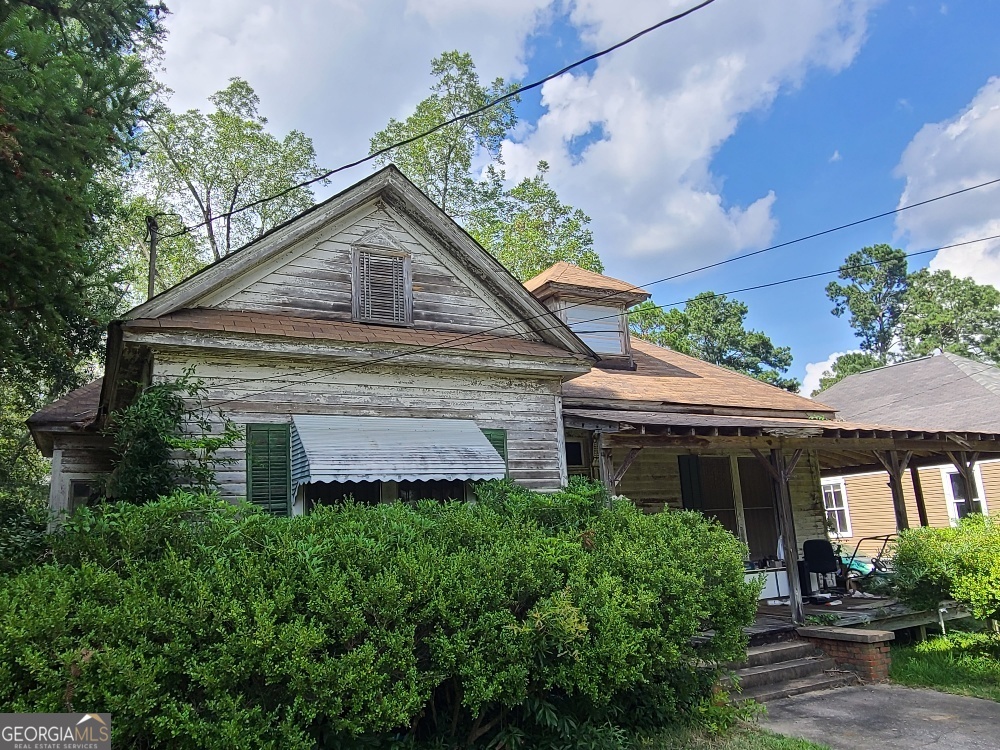 Step back in time and discover the untapped potential of this historic Folk Victorian home! Nestled in a charming, established neighborhood, this 3-bedroom, 2-bathroom gem is a blank canvas for the visionary homeowner. Built in 1930, it oozes with the timeless character and architectural details that define the Folk Victorian style, including a classic front porch and a distinctive gabled roofline. This home is ready to be brought back to its former glory. Inside, you'll find a spacious layout along with high ceilings that create an open and airy feel. Imagine yourself creating the kitchen of your dreams or transforming the bedrooms into peaceful, light-filled sanctuaries. This is more than just a house; it's an opportunity to own a piece of history and create a home that is uniquely yours. With a little love and tender care, this diamond in the rough can once again shine as a true masterpiece. Don't miss your chance to turn this historic treasure into a forever home.