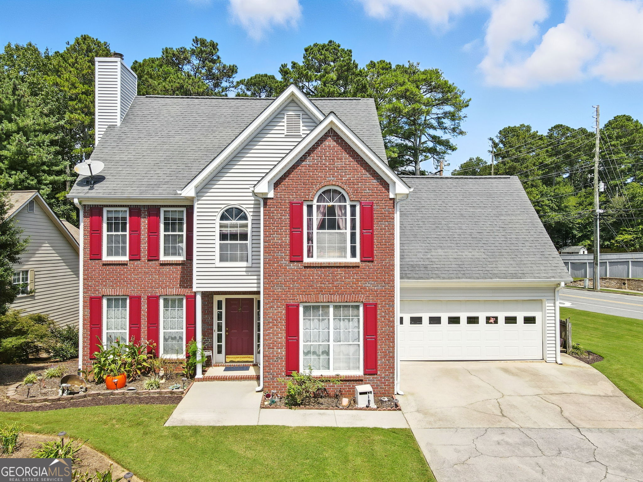 Welcome home to Woodstock, uniquely known for blending small-town charm with modern amenities. Nestled just outside of Towne Lake, this brick and vinyl two-story home is conveniently located near schools, shopping, and dining. With 4 bedrooms, 2.5 bathrooms, and 2,320 sq ft of living space on a landscaped 0.35-acre lot with a voluntary HOA, this home is the perfect place to settle in. The main level features a well-designed floor plan with a living room, eat-in kitchen, and a formal dining room or office, filled with natural light. The kitchen includes a gas stove, pantry, and access to the back deck-ideal for grilling or outdoor dining. Upstairs, the oversized primary suites has tray ceilings and lots of natural light, offering dual vanities, a walk-in closet, and a full bath. Three additional bedrooms and a shared bathroom complete the upper level. The two-car garage provides storage for tools, appliances, or seasonal items, while the four-car driveway offers plenty of space for cars, trailers, boats, or even an RV. Recent updates include a newer HVAC, water heater, and a 30-year architectural shingle roof. The unfinished daylight basement adds 1,600 sq ft of potential living space, perfect for a family room, media room, or guest suite, with its own private entrance to the backyard. The front and backyards are nicely landscaped with rose bushes, trees, shrubs, and have great curb appeal. The level backyard is ideal for volleyball, entertaining, gardening, or furry friends, with room to add a firepit or fence for extra privacy. Located minutes from downtown Woodstock, the Outlet Shoppes at Atlanta, the largest outdoor mall in Georgia, Northside Hospital, and local restaurants, breweries, and coffee shops, this home offers convenience and community. Outdoor lovers will enjoy nearby Olde Rope Mill Park, Woofstock Dog Park, and Lake Allatoona for hiking, biking, and water activities. Easy access to I-575 and the express lane makes commuting a breeze. Be surrounded by everything Woodstock has to offer - shopping, movies or live theater, outdoor adventures, and vibrant community events.